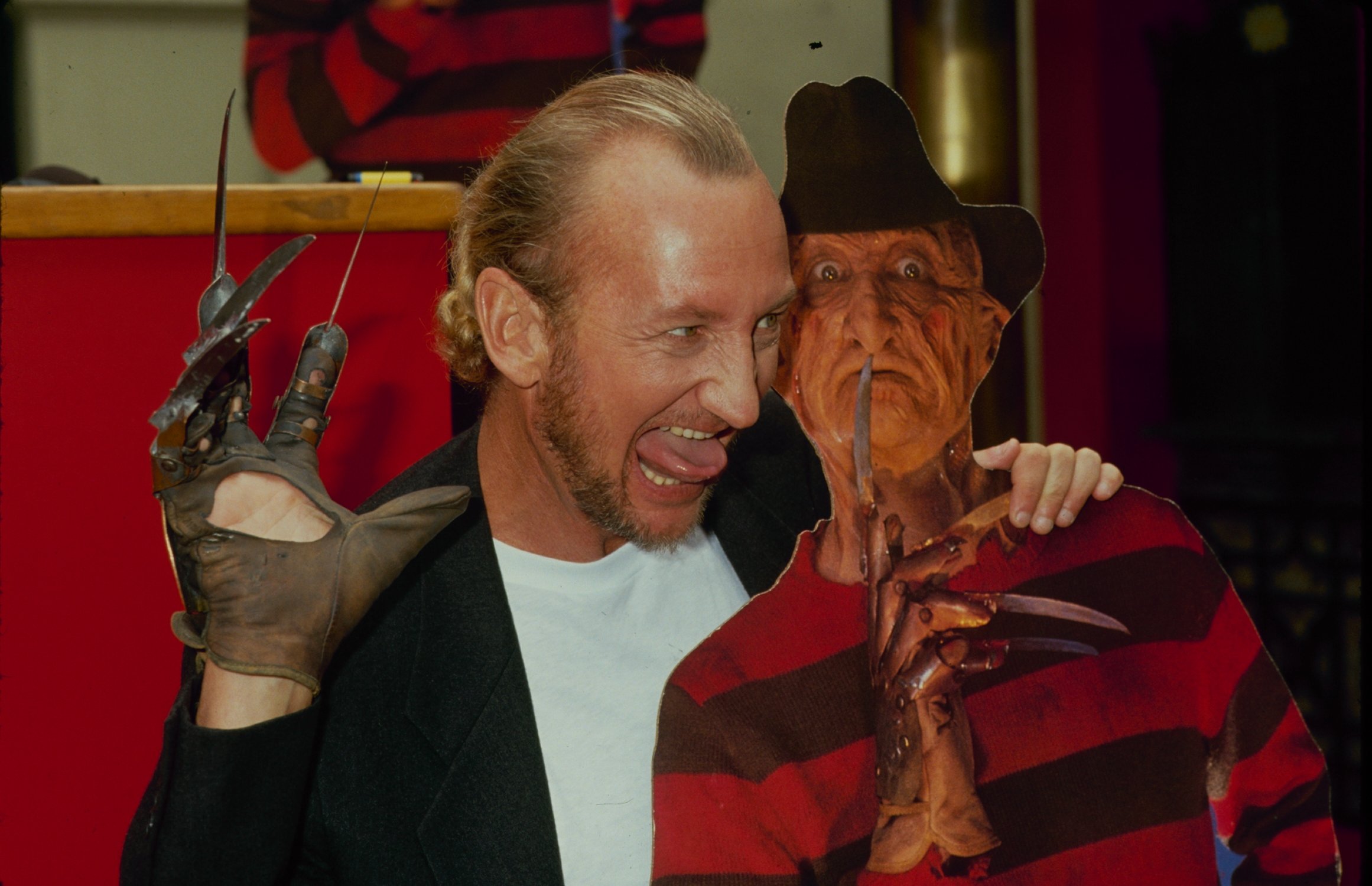 Robert Englund poses with Freddy Krueger cutout