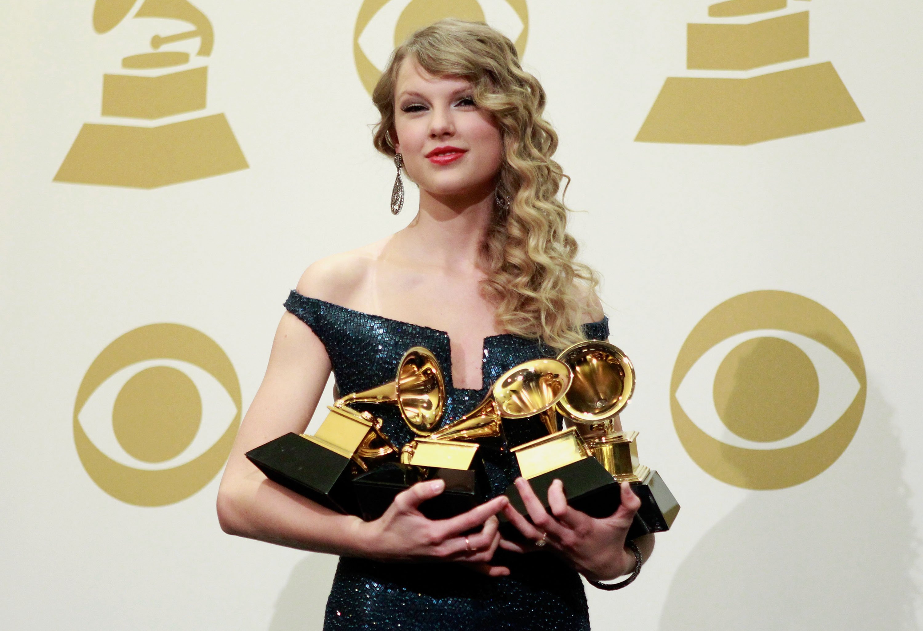 Taylor Swift poses with her Grammys at the 2010 Grammy Awards