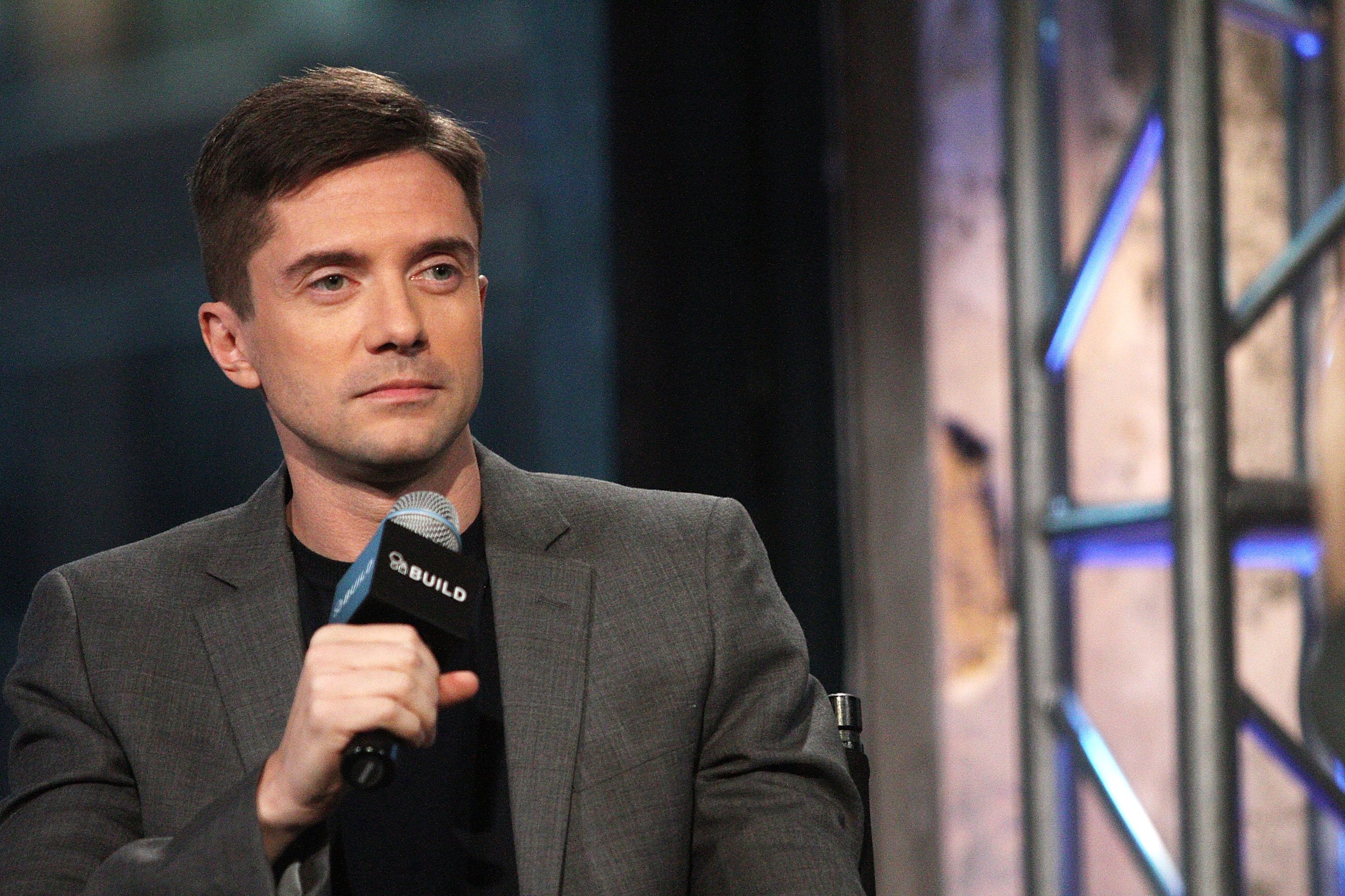 Topher Grace with a microphone