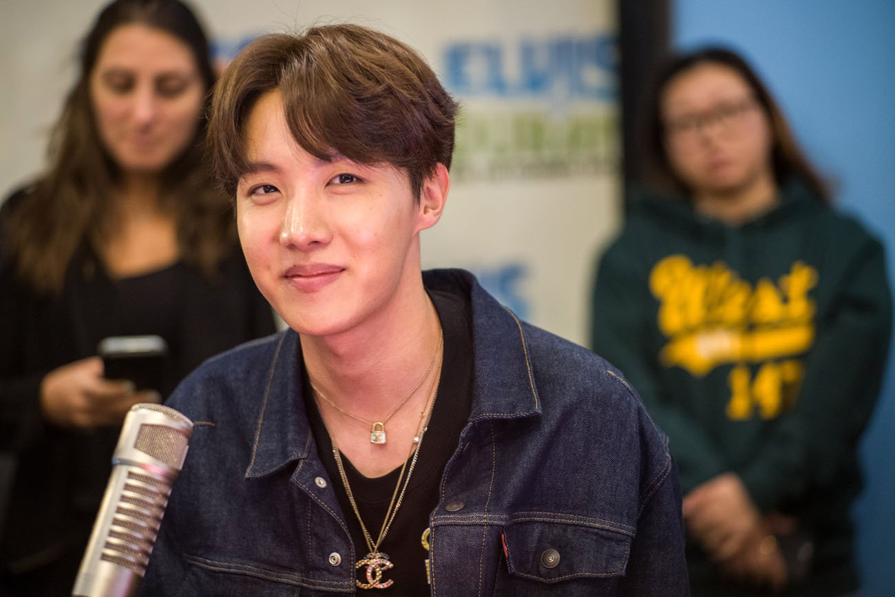BTS J-Hope looking on with microphone in front of him