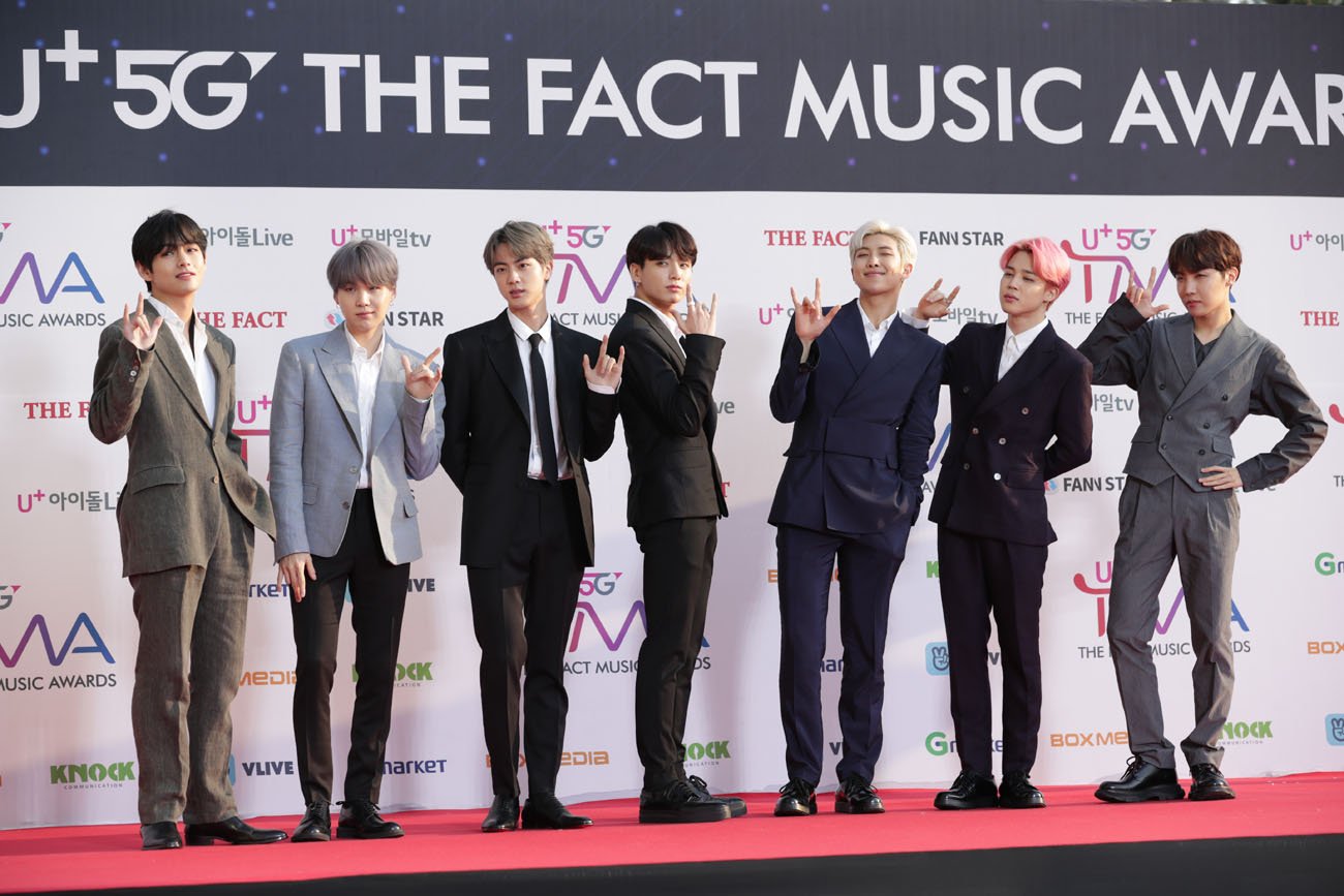BTS standing on red carpet and in front of white background