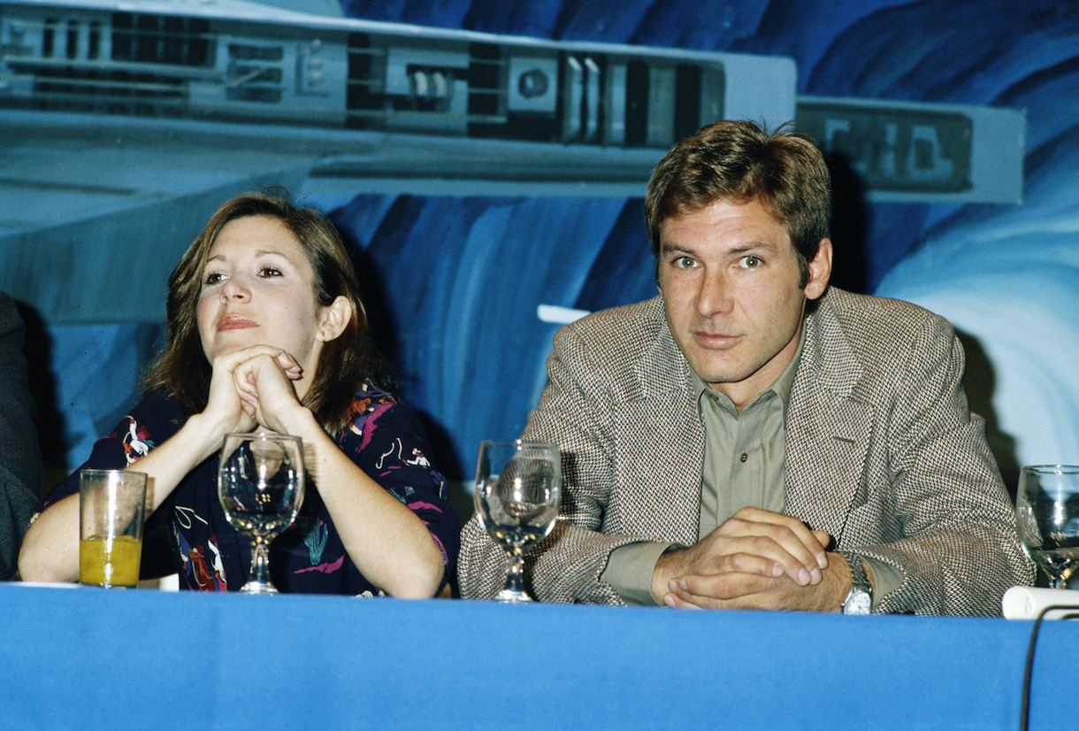 Carrie Fisher and Harrison Ford at a press conference for one of the 'Star Wars' films, circa 1980