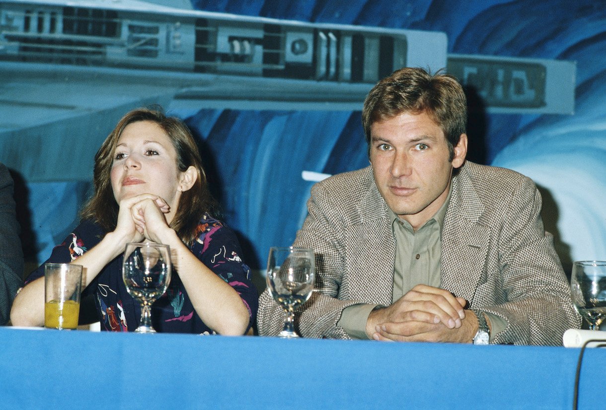 Carrie Fisher and Harrison Ford at a press conference for one of the 'Star Wars' films, circa 1980