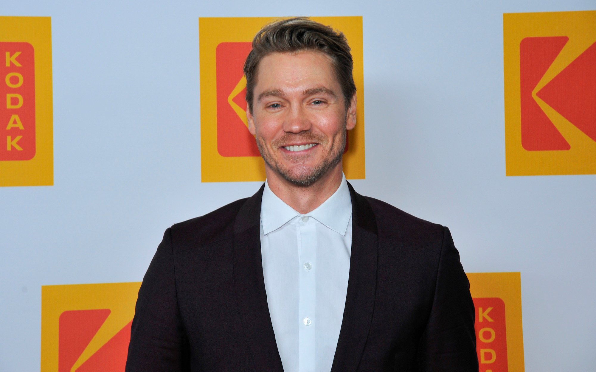Chad Michael Murray smiling in front of a white background