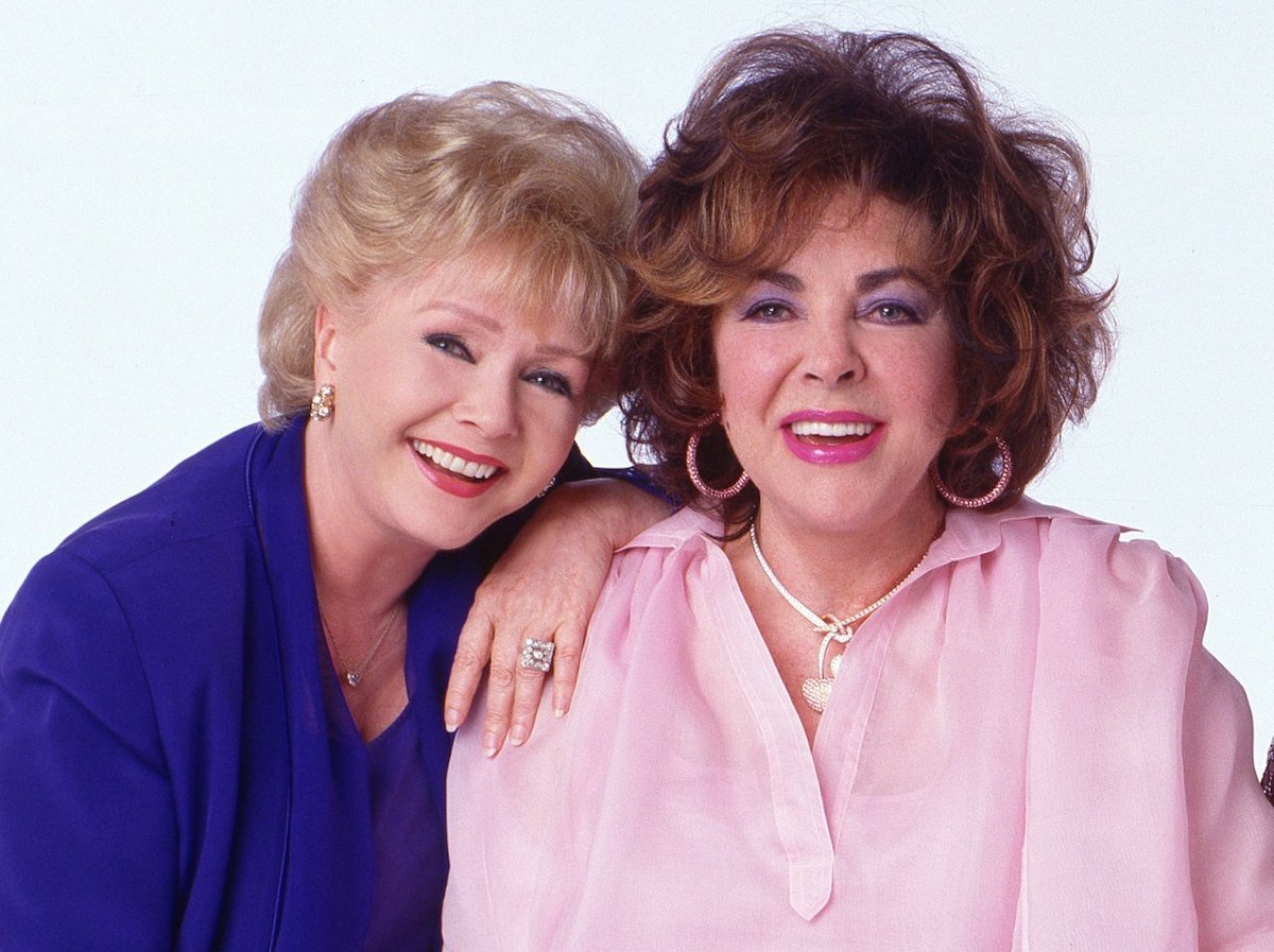 Debbie Reynolds and Elizabeth Taylor in a press photo for 'These Old Broads' written by Carrie Fisher | Timothy White/Walt Disney Television via Getty Images
