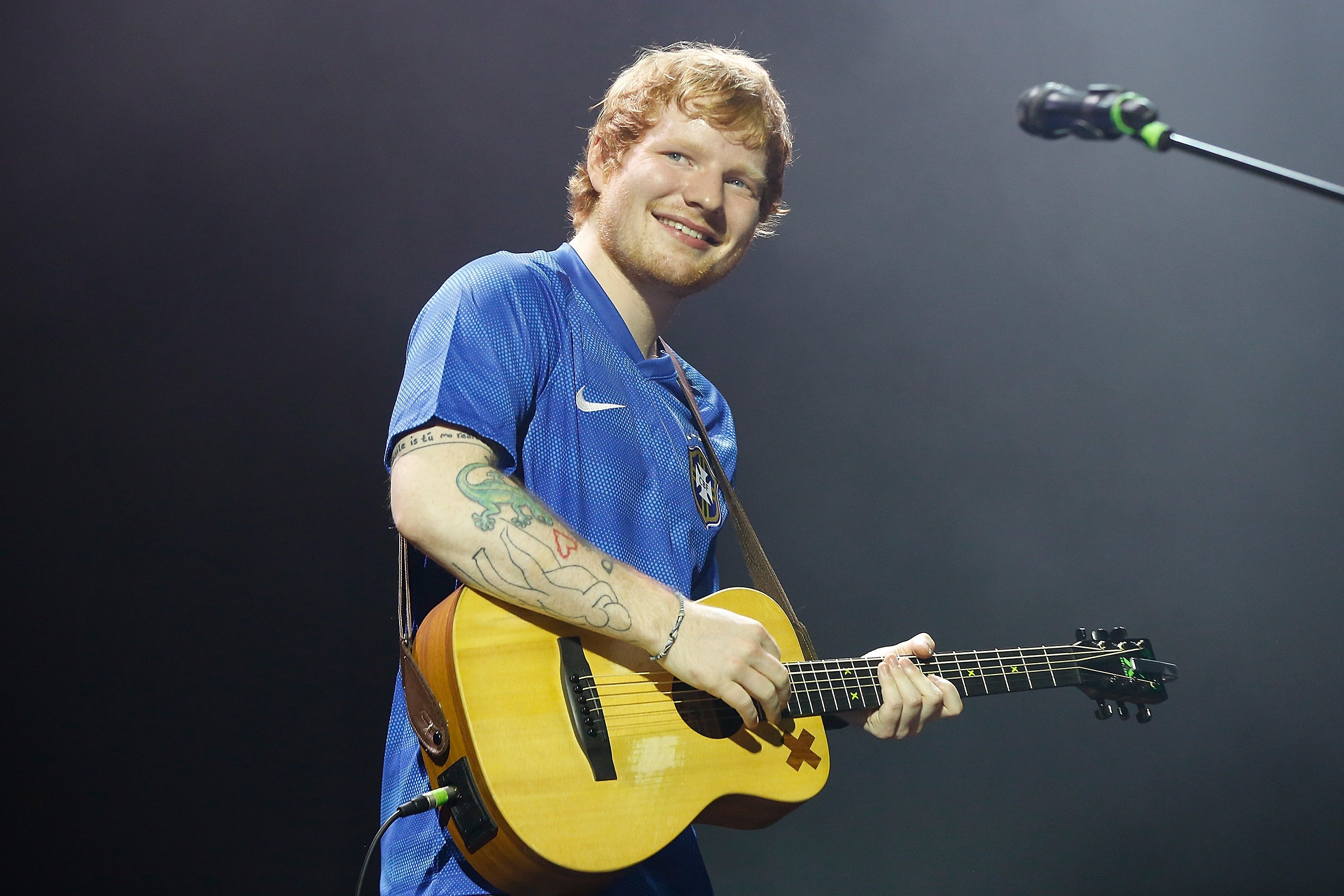 Ed Sheeran smiles during a concert in Brazil
