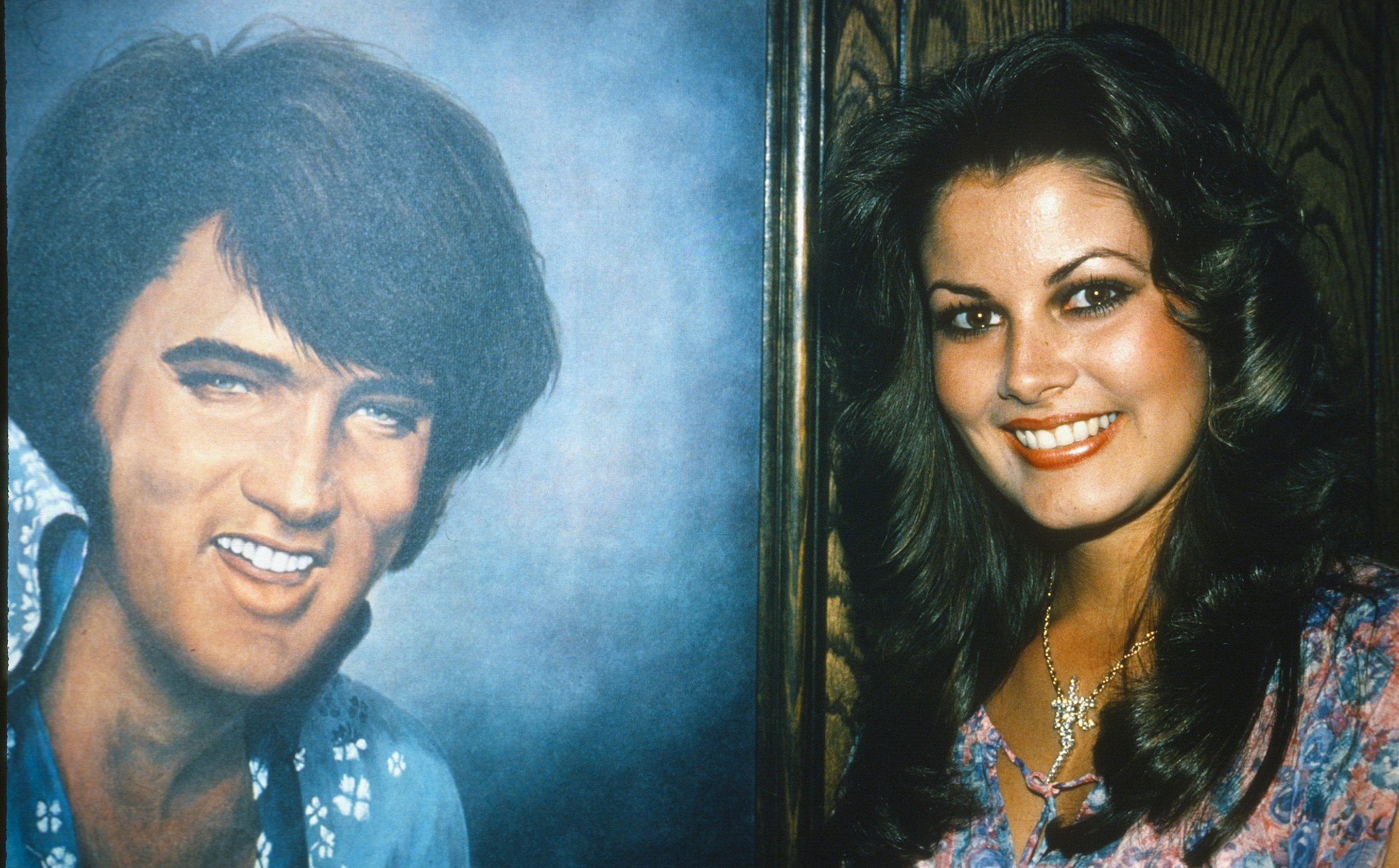 Ginger Alden, fiancee of Elvis Presley, next to a portrait of Presley