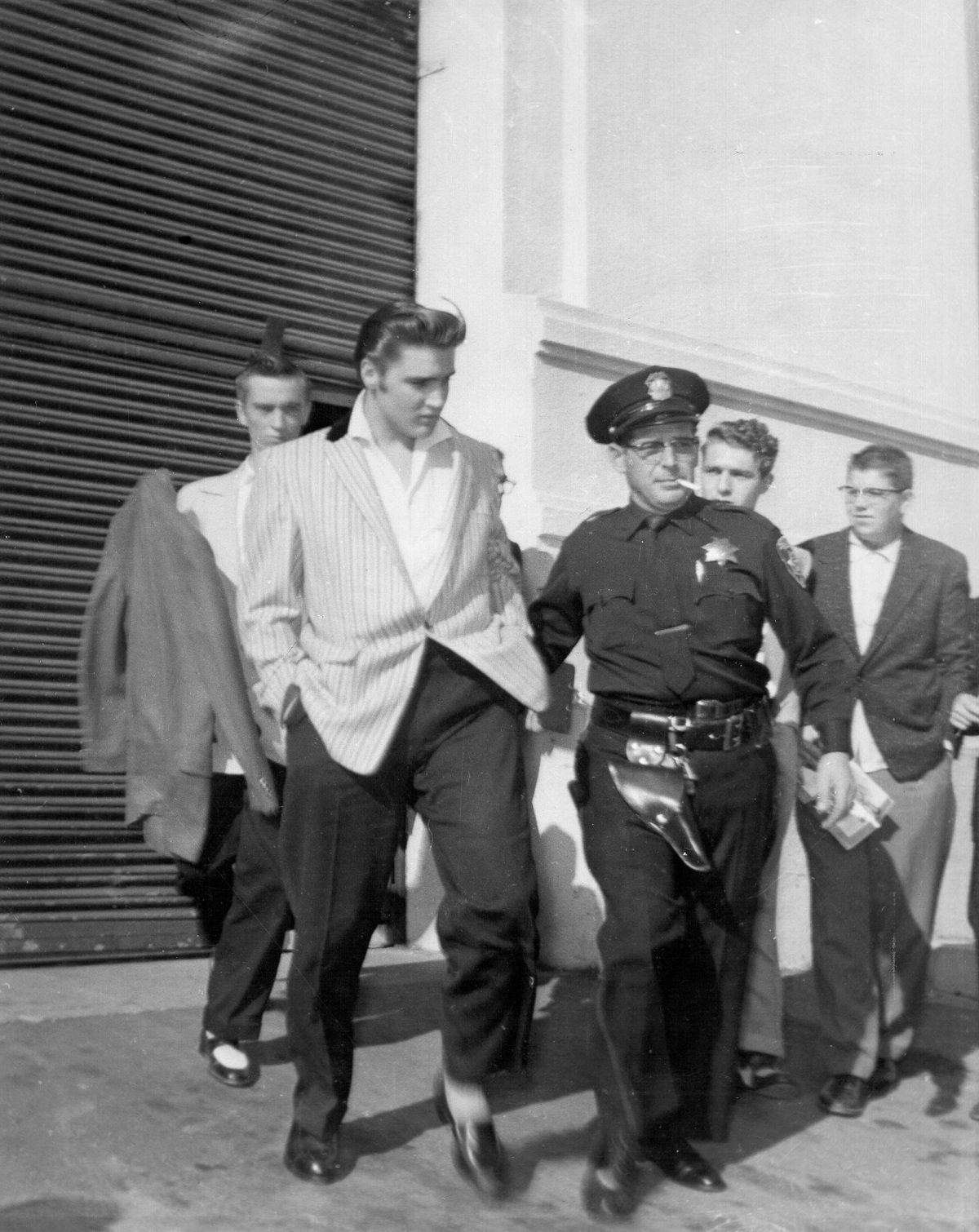 Elvis Presley with police and security in 1956