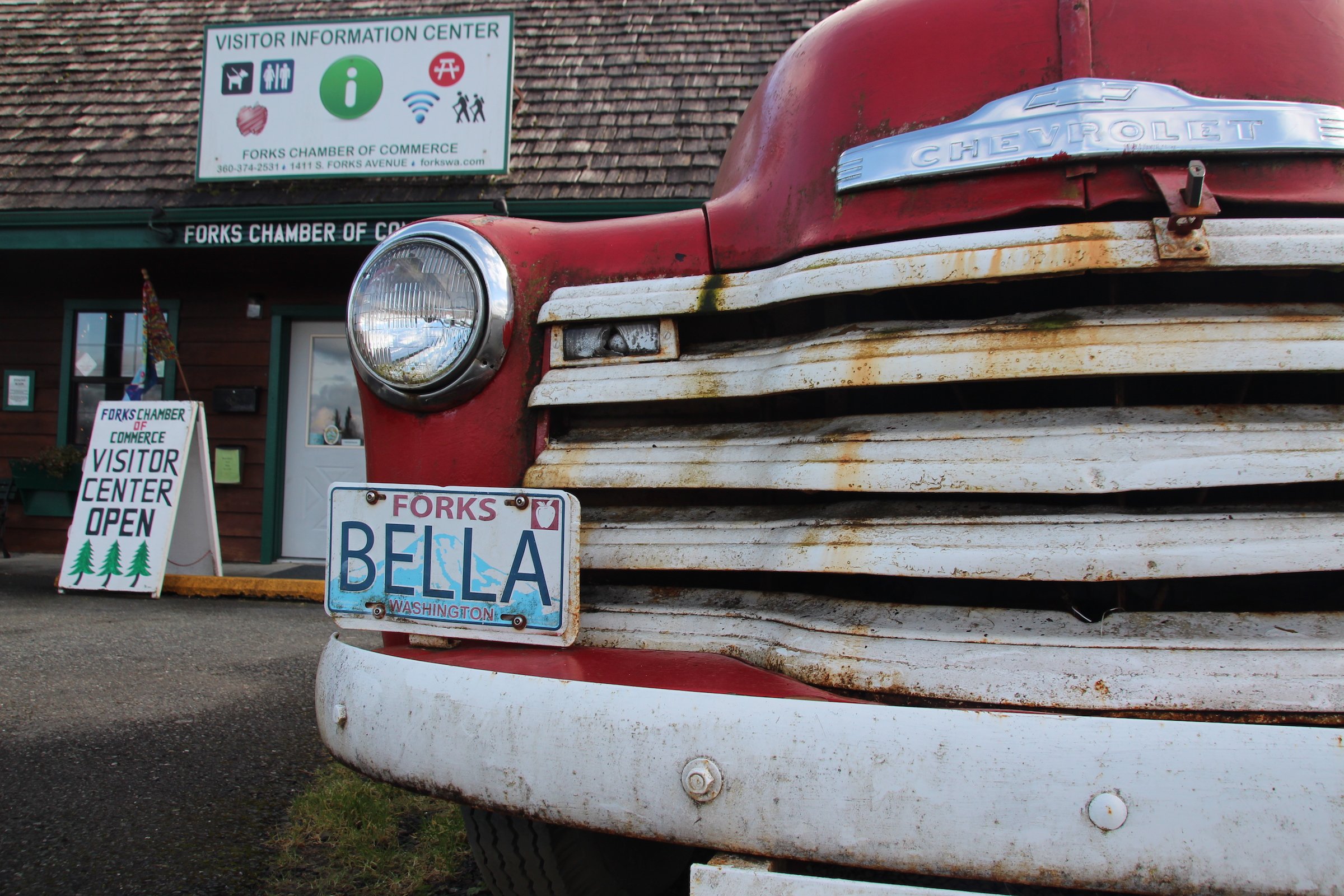 An old Chevrolet is parked in front of the visitor centre in the small town of Forks
