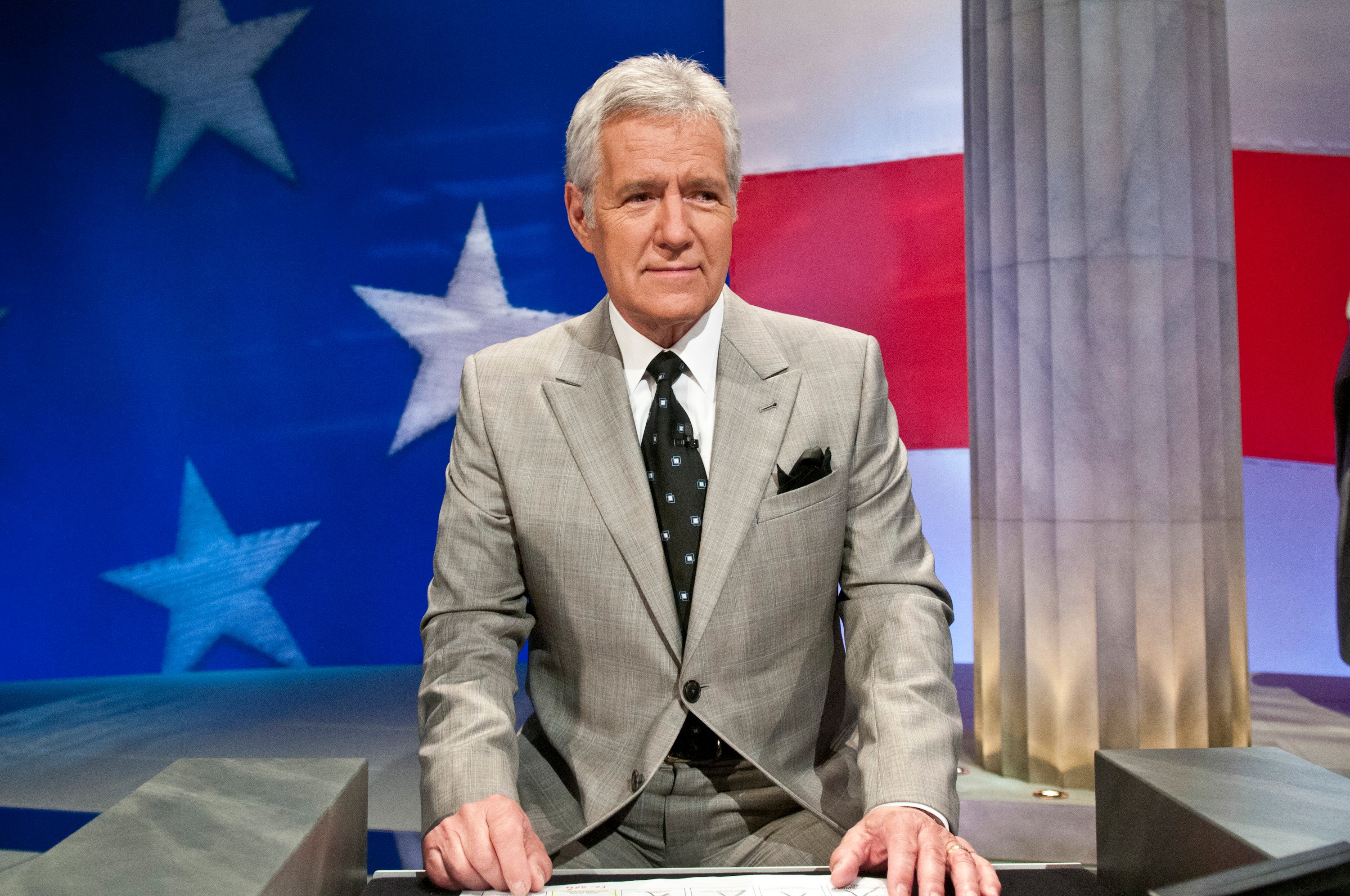 Alex Trebek stands at his podium during a taping of 'Jeopardy!'