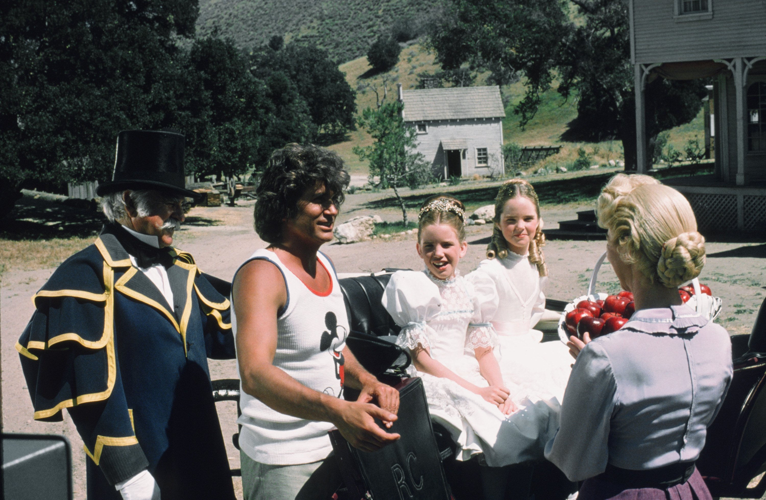 Michael Landon on the set of 'Little House on the Prairie' with cast, 1975