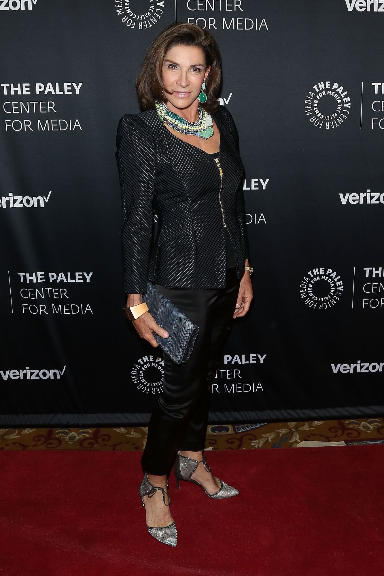 Hilary Farr smiling in front of a black background