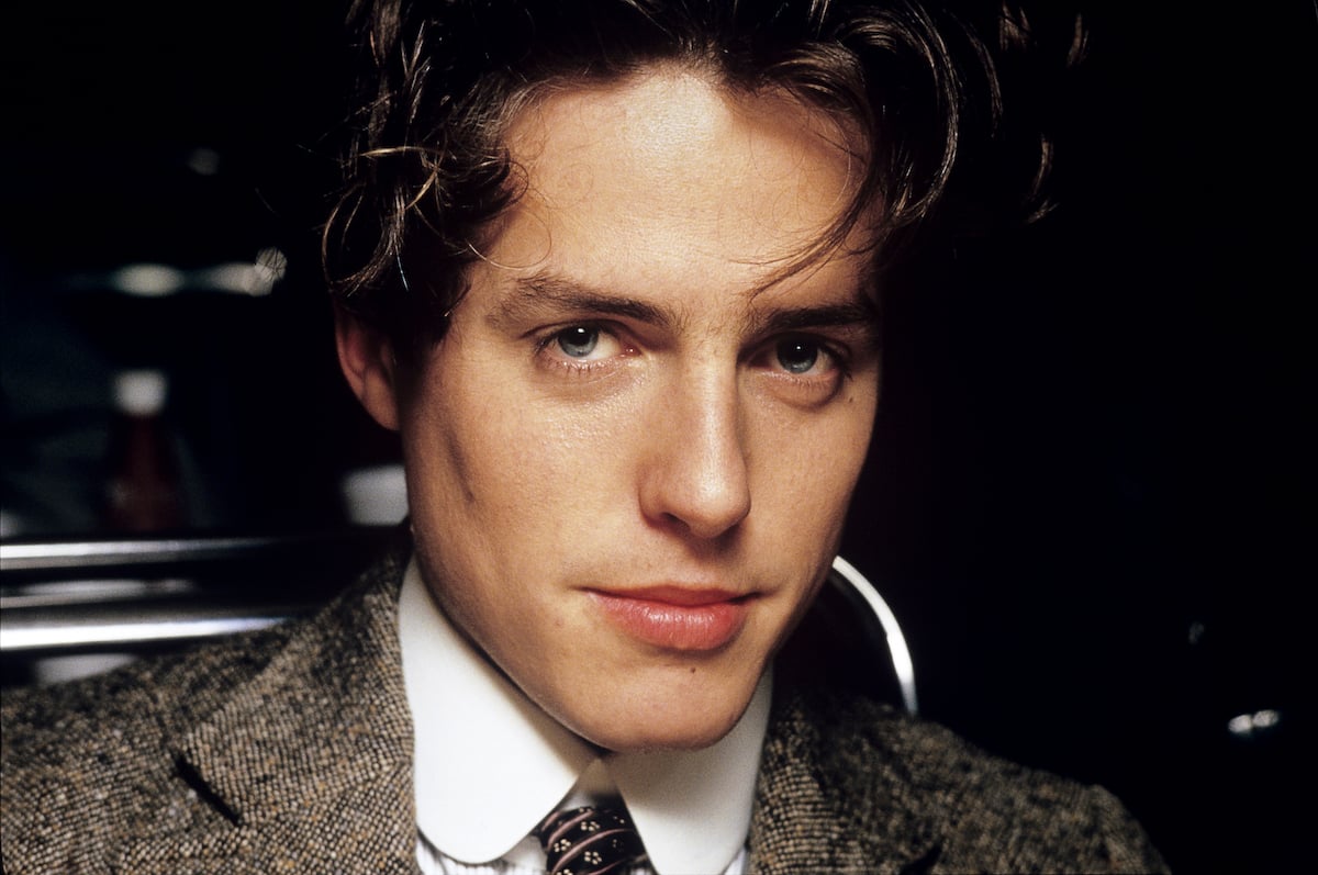 Hugh Grant poses while filming 'Maurice,' in December 1986