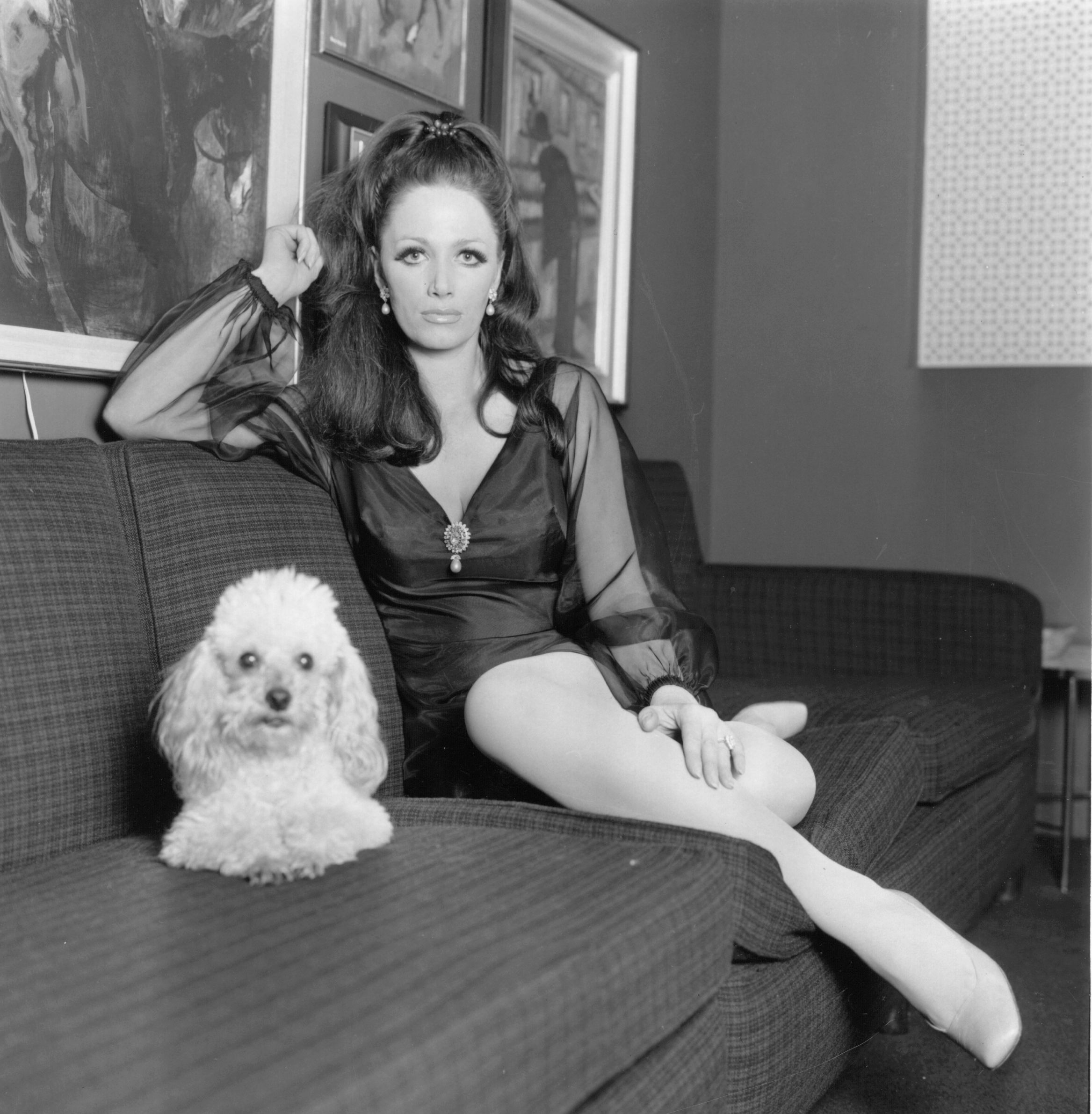 Jackie Collins, at home with her pet poodle