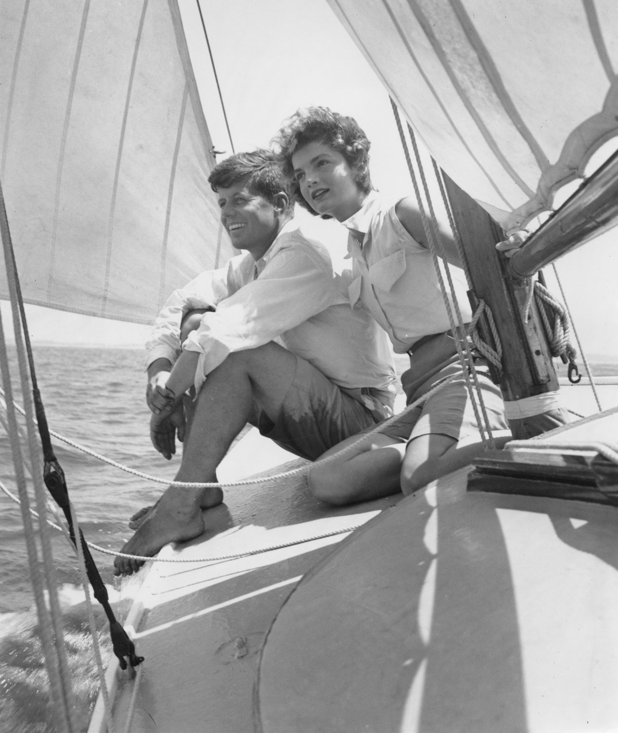 HYANNIS PORT, MA - 1953: Senator John F. Kennedy and fiance Jacqueline Bouvier go sailing while on vacation at the Kennedy compound