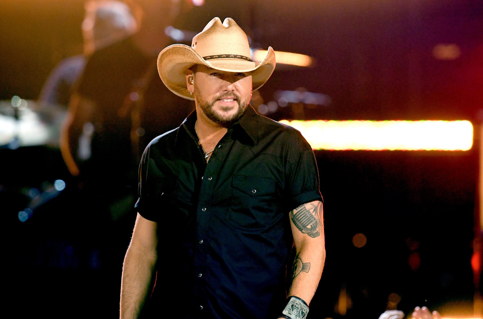 Jason Aldean smiling on stage