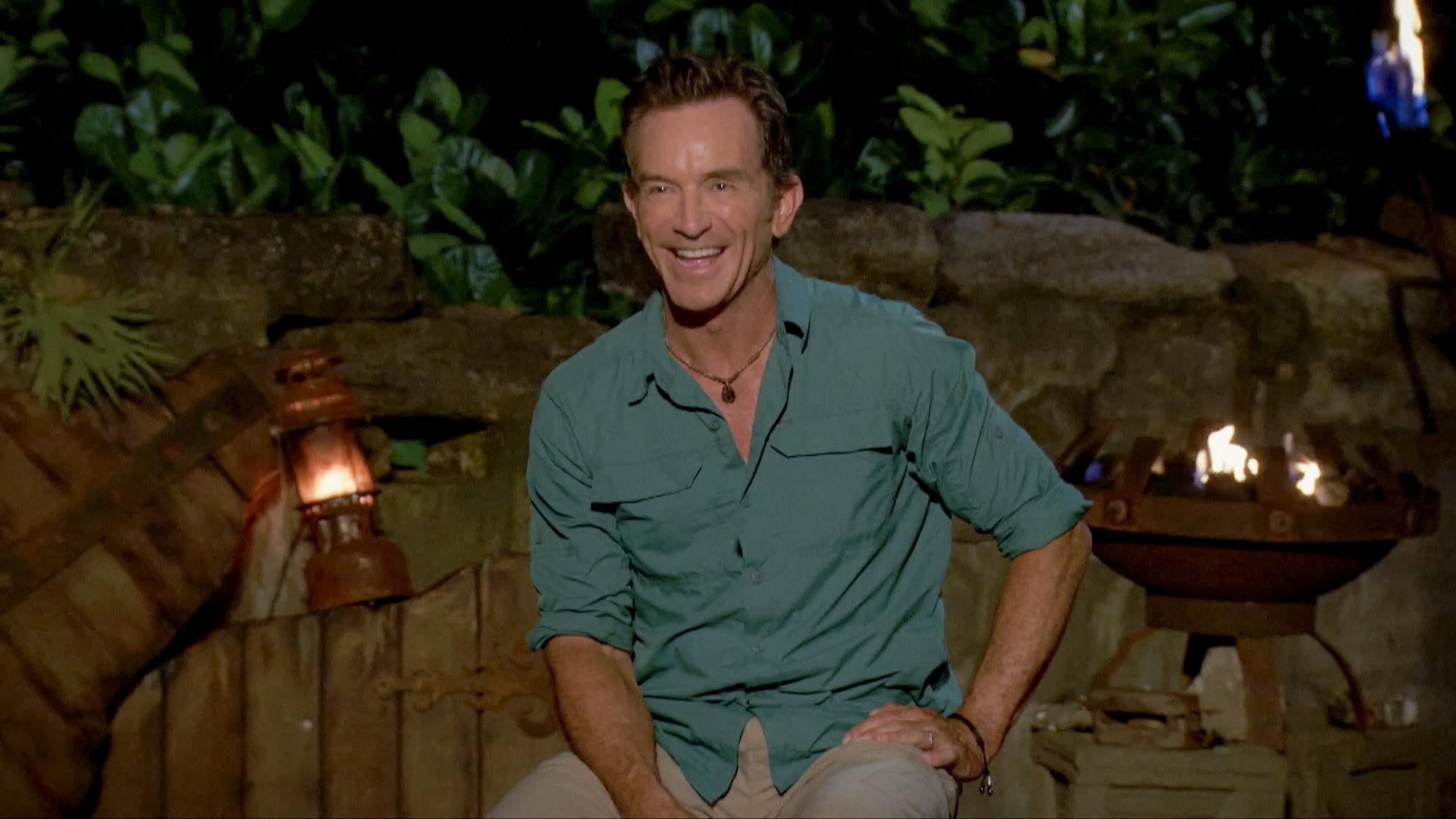 Jeff Probst smiling, sitting at tribal council