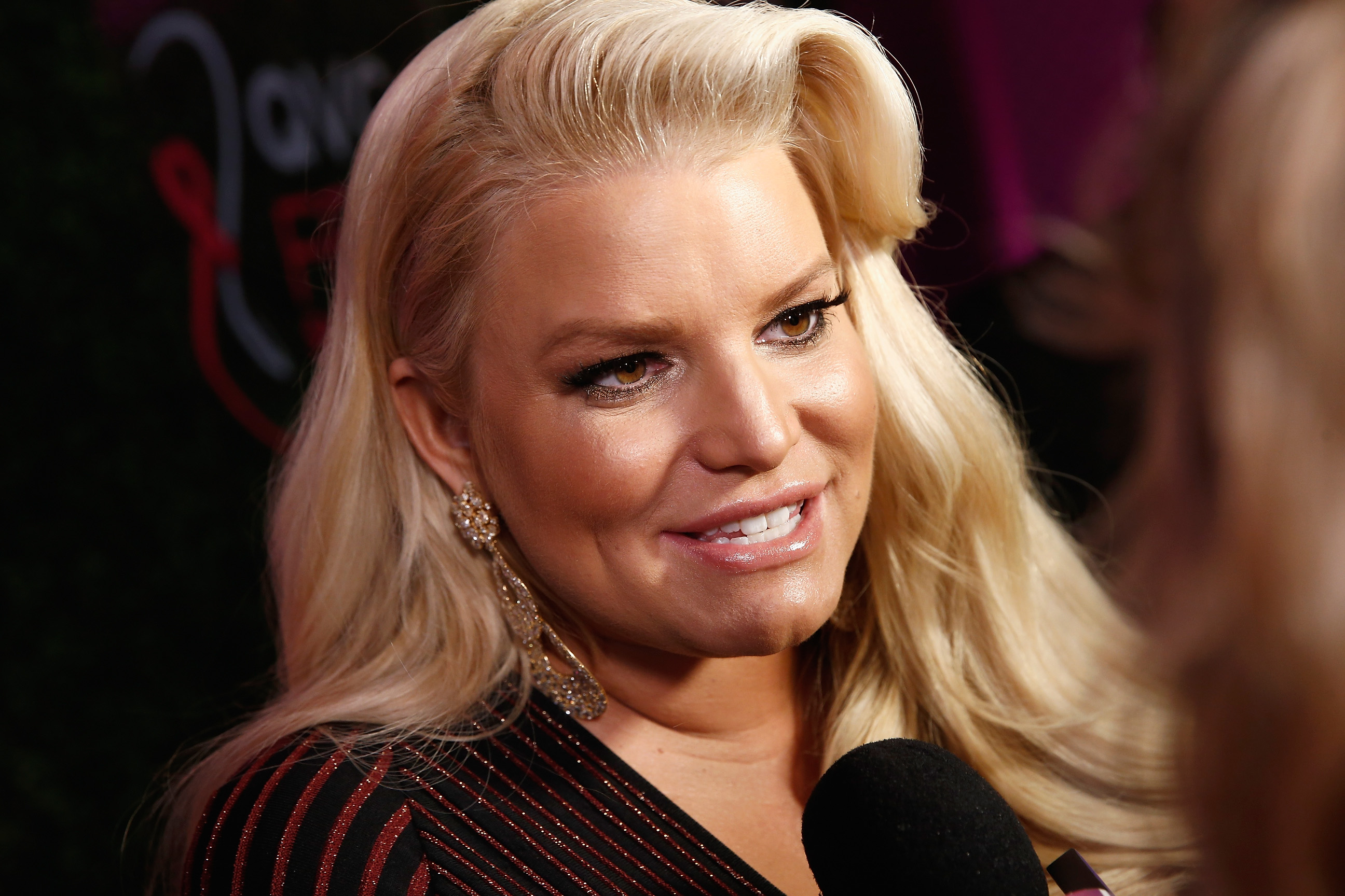 Jessica Simpson smiles for a photo on the red carpet