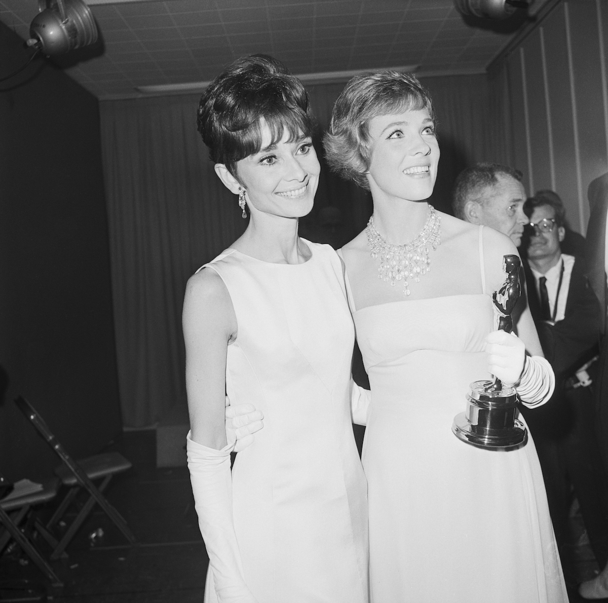 Julie Andrews (R) and Audrey Hepburn (L) stand after Andrews received her Oscar. 1965.