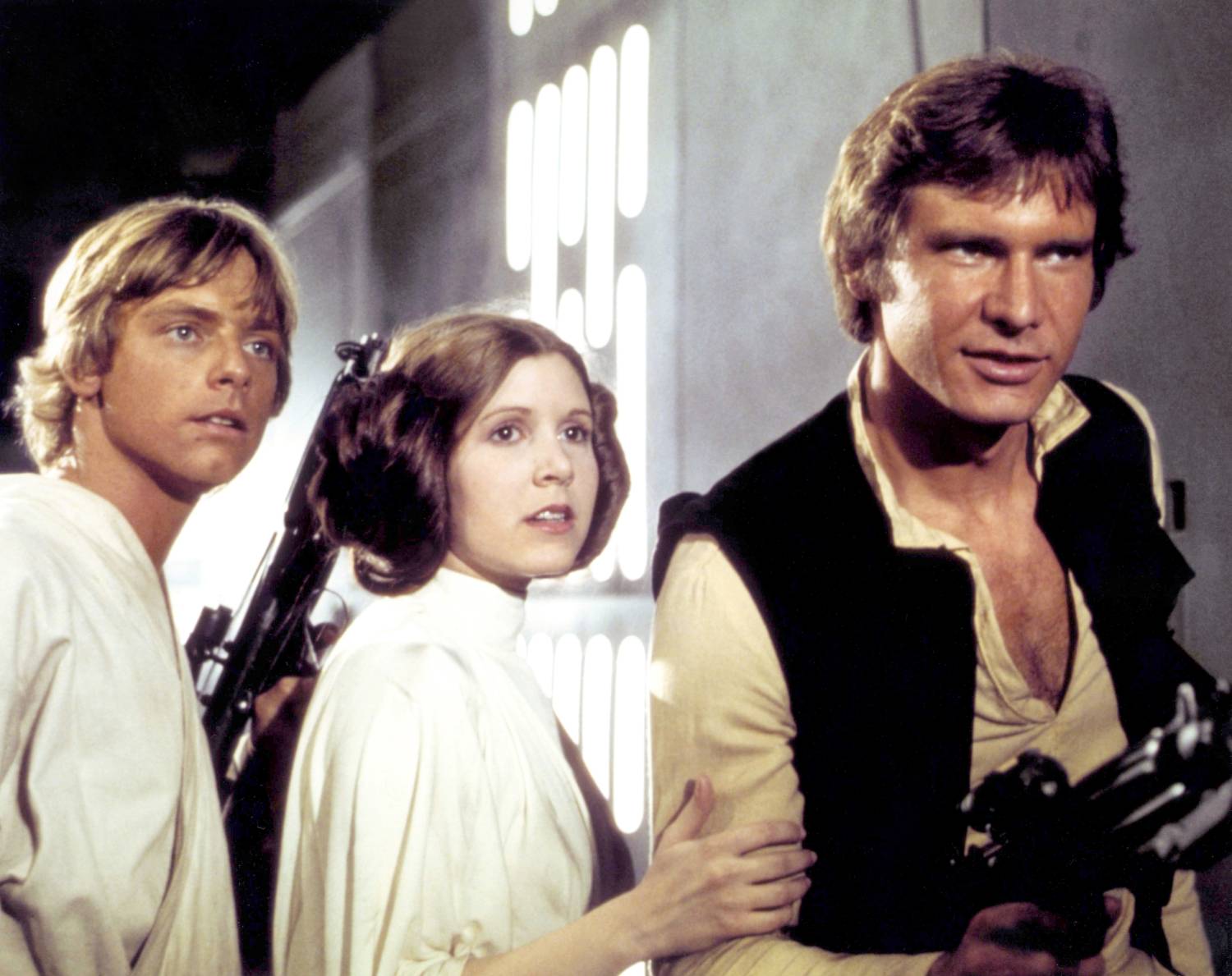 American actors Mark Hamill, Carrie Fisher and Harrison Ford on the set of Star Wars: Episode IV - A New Hope written, directed and produced by Georges Lucas. 