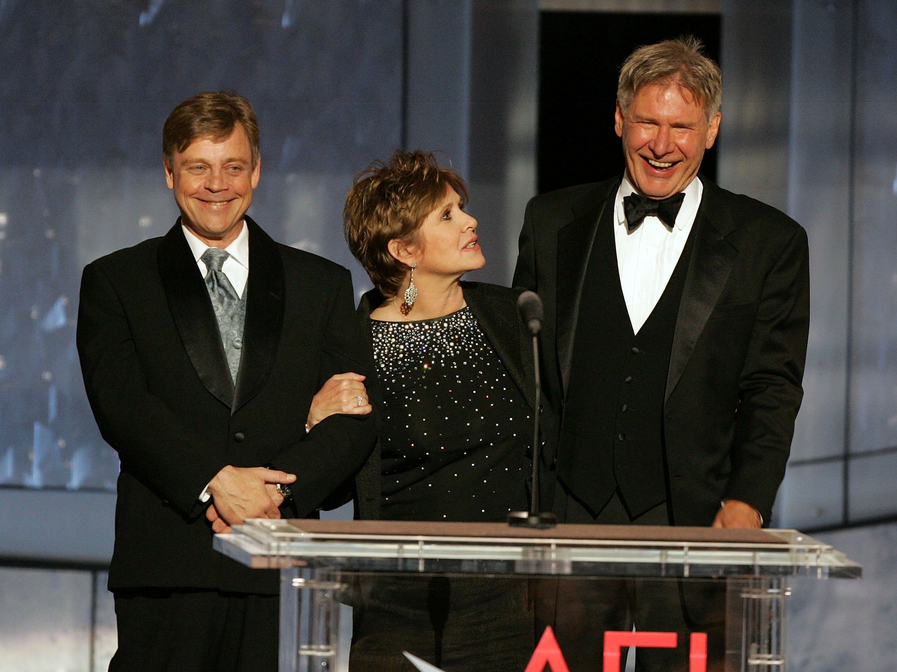 ctors Mark Hamill, Carrie Fisher and Harrison Ford speak onstage during the 33rd AFI Life Achievement Award tribute to George Lucas at the Kodak Theatre on June 9, 2005 in Hollywood, California. 