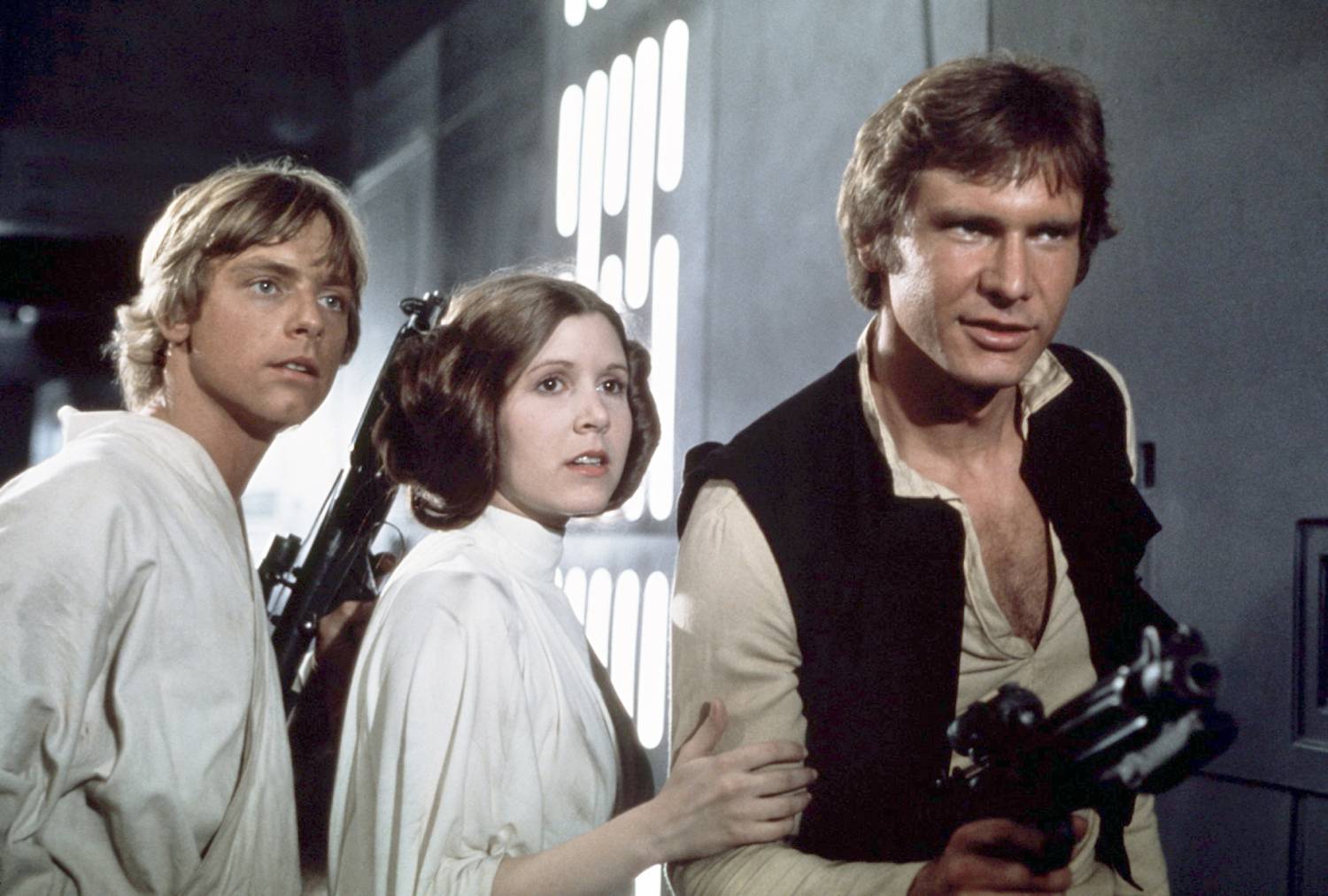 American actors Mark Hamill, Carrie Fisher and Harrison Ford on the set of Star Wars: Episode IV - A New Hope written, directed and produced by Georges Lucas.