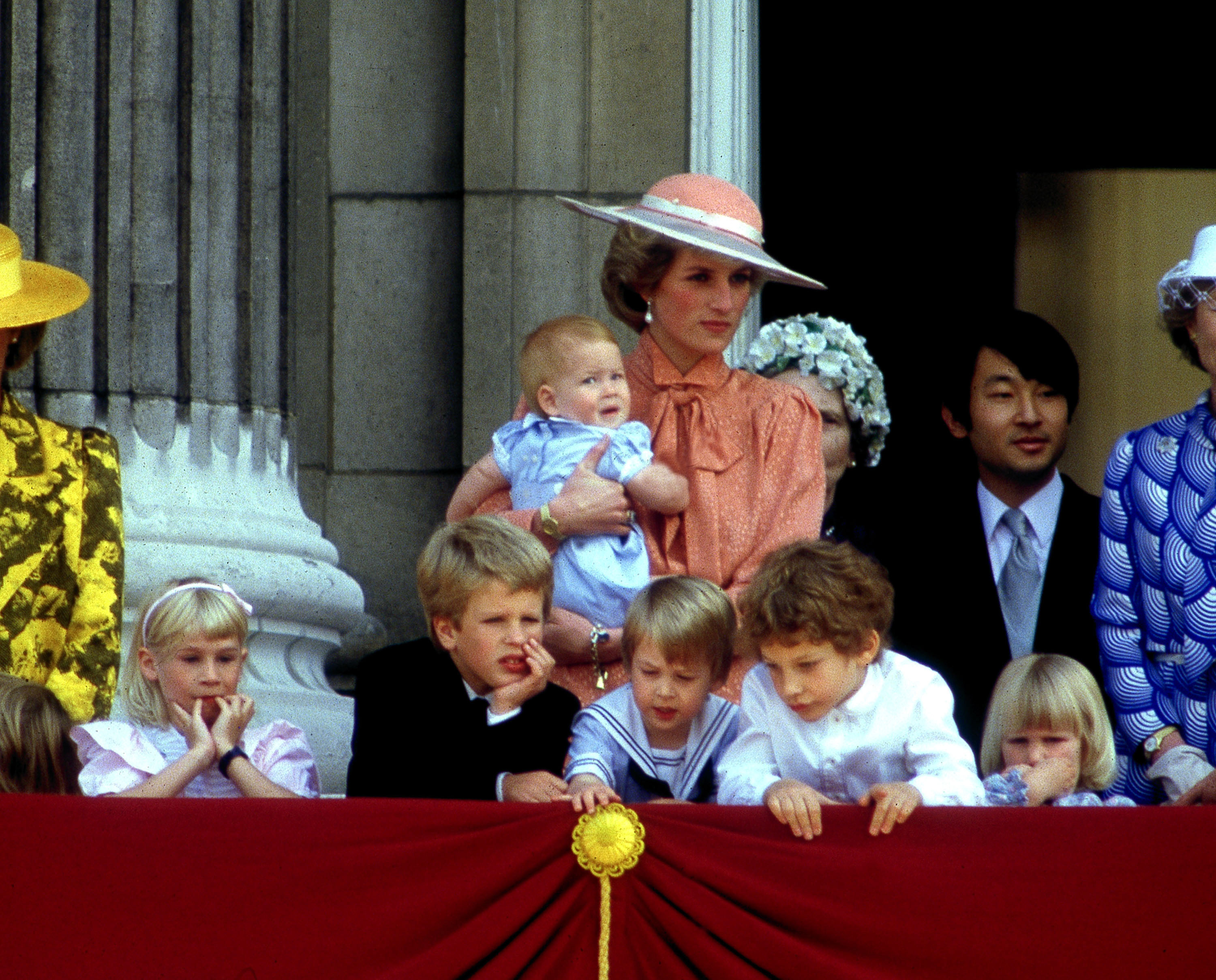 Princess Diana holding Prince Harry with Lady Davina Windsor, Peter Phillips, Prince William, Lord Frederick Windsor, and Lady Rose Windsor in the foreground