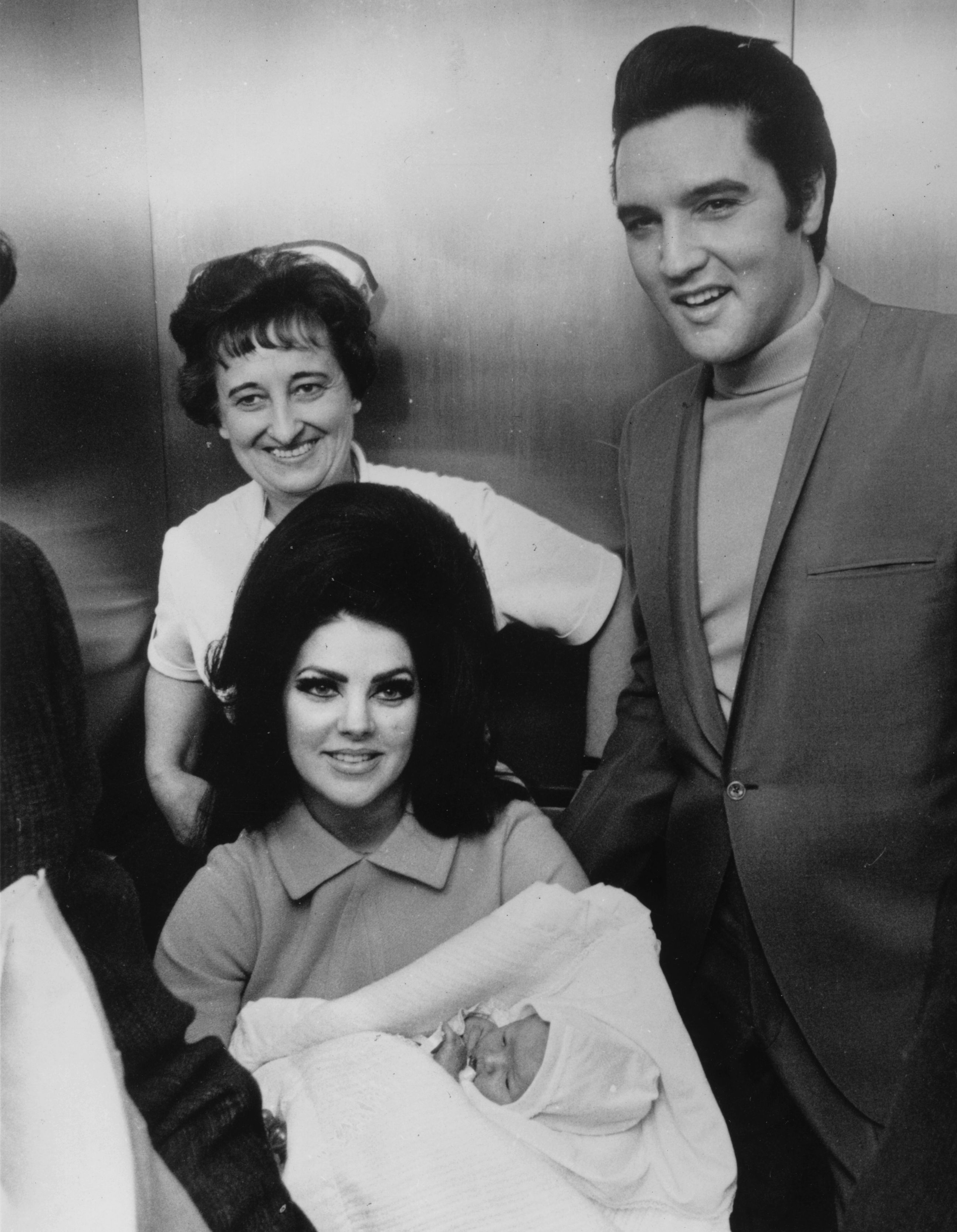 Rock 'n' roll superstar Elvis Presley (1935 - 1977), with his wife Priscilla and their new-born baby Lisa Marie, at the Baptist Hospital at Memphis, Tennessee