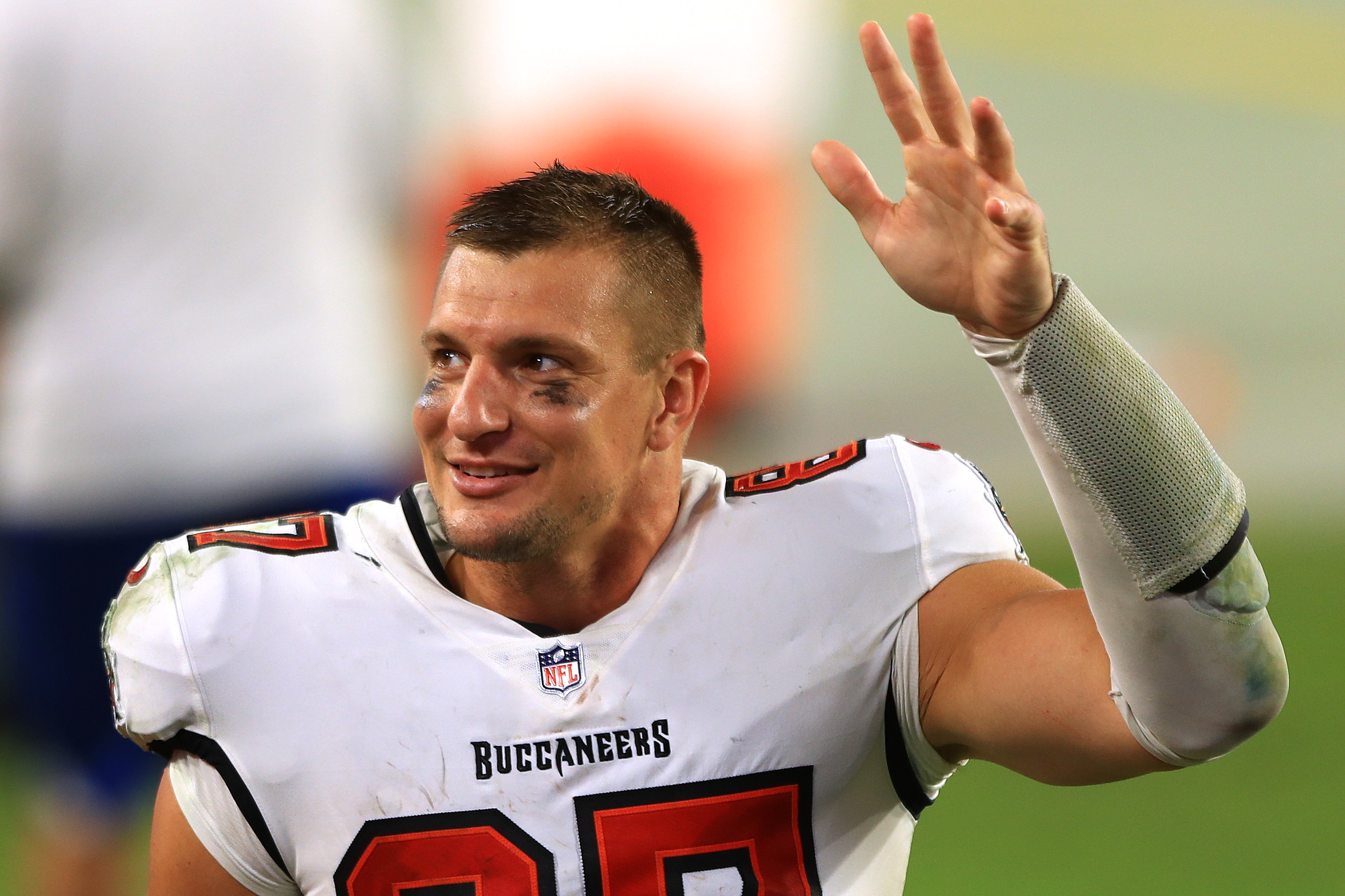 Rob Gronkowski waves as he walks off the football field