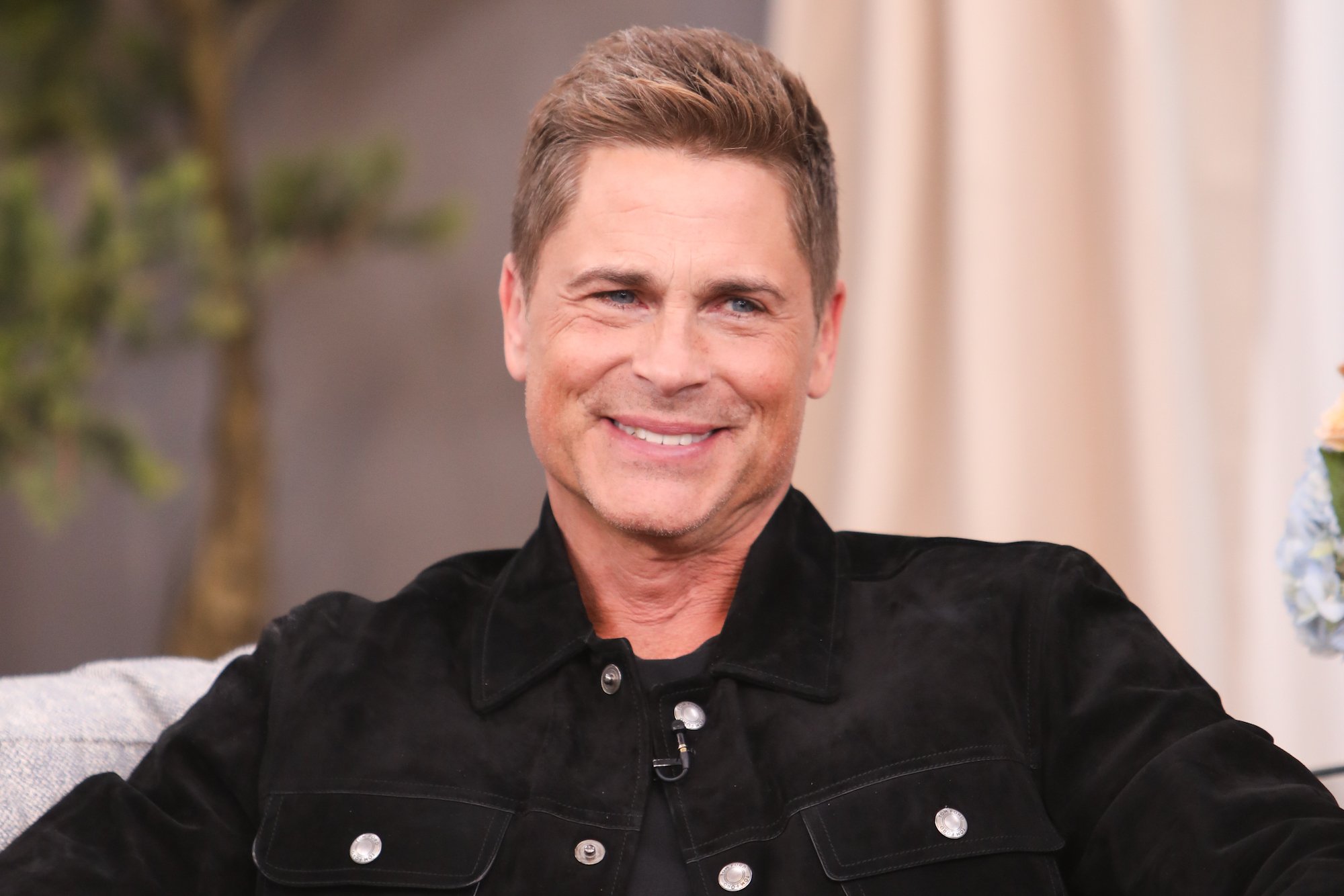 Rob Lowe smiling, turned to the side