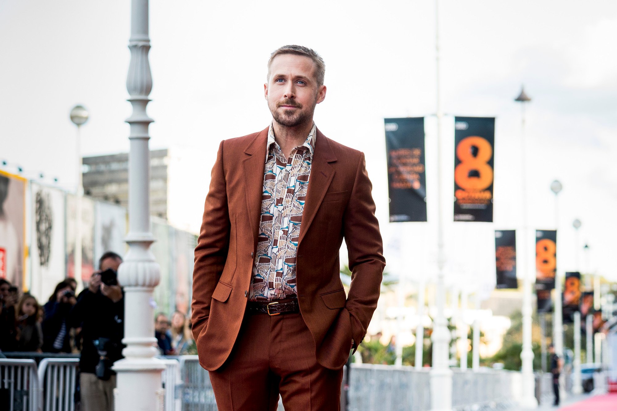 Ryan Gosling smiling, walking a red carpet