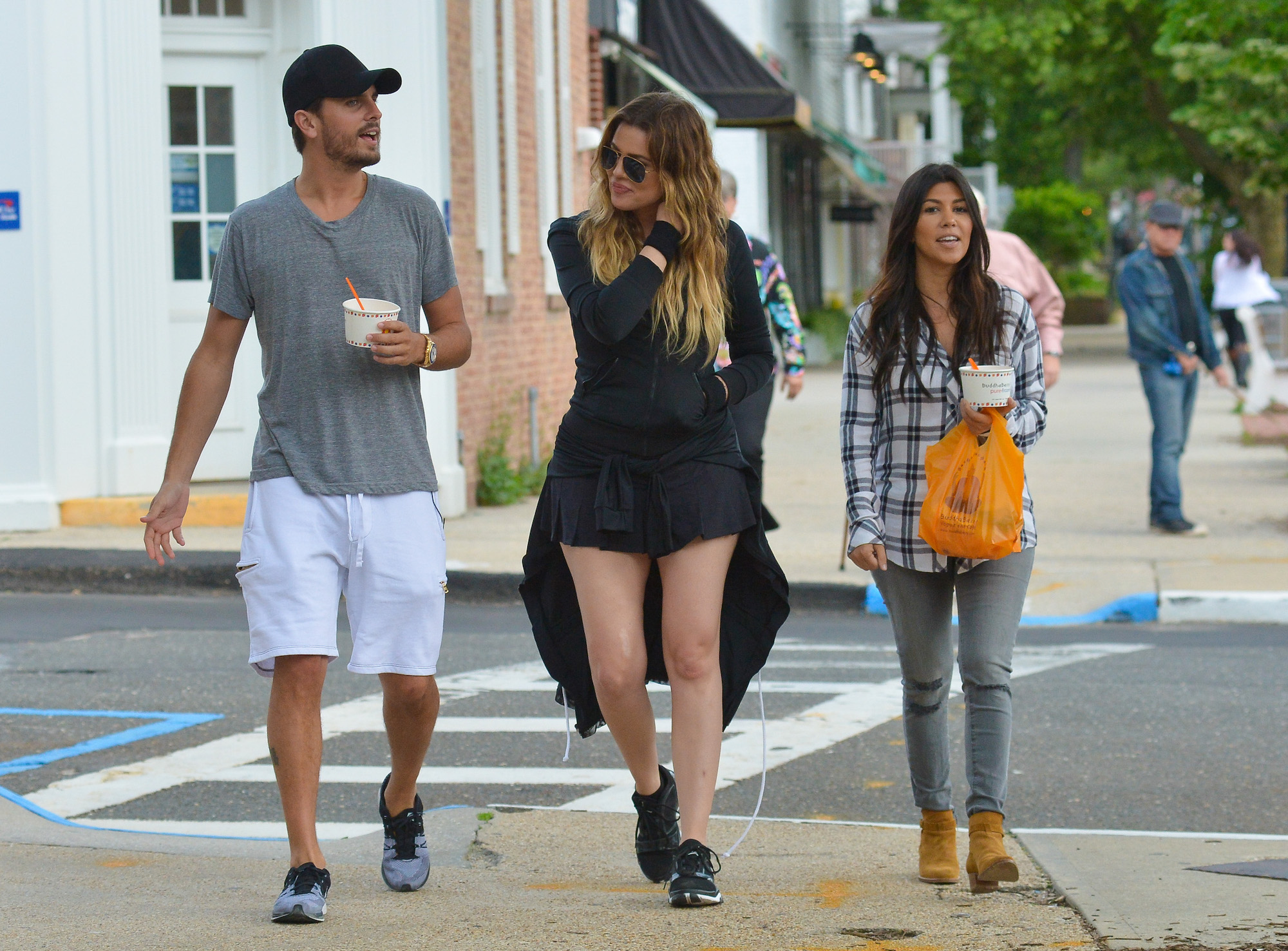 (L-R) Scott Disick, Khloé Kardashian, and Kourtney Kardashian walking down a sidewalk