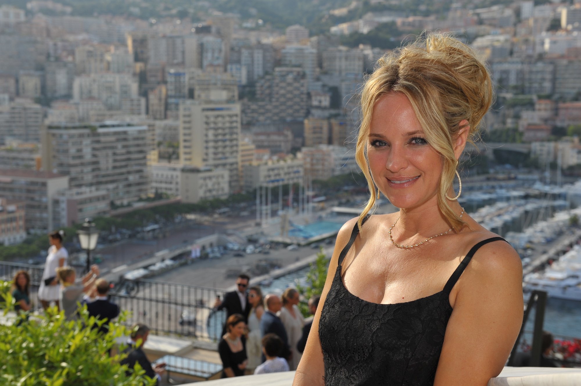 Sharon Case smiling in front of a cityscape