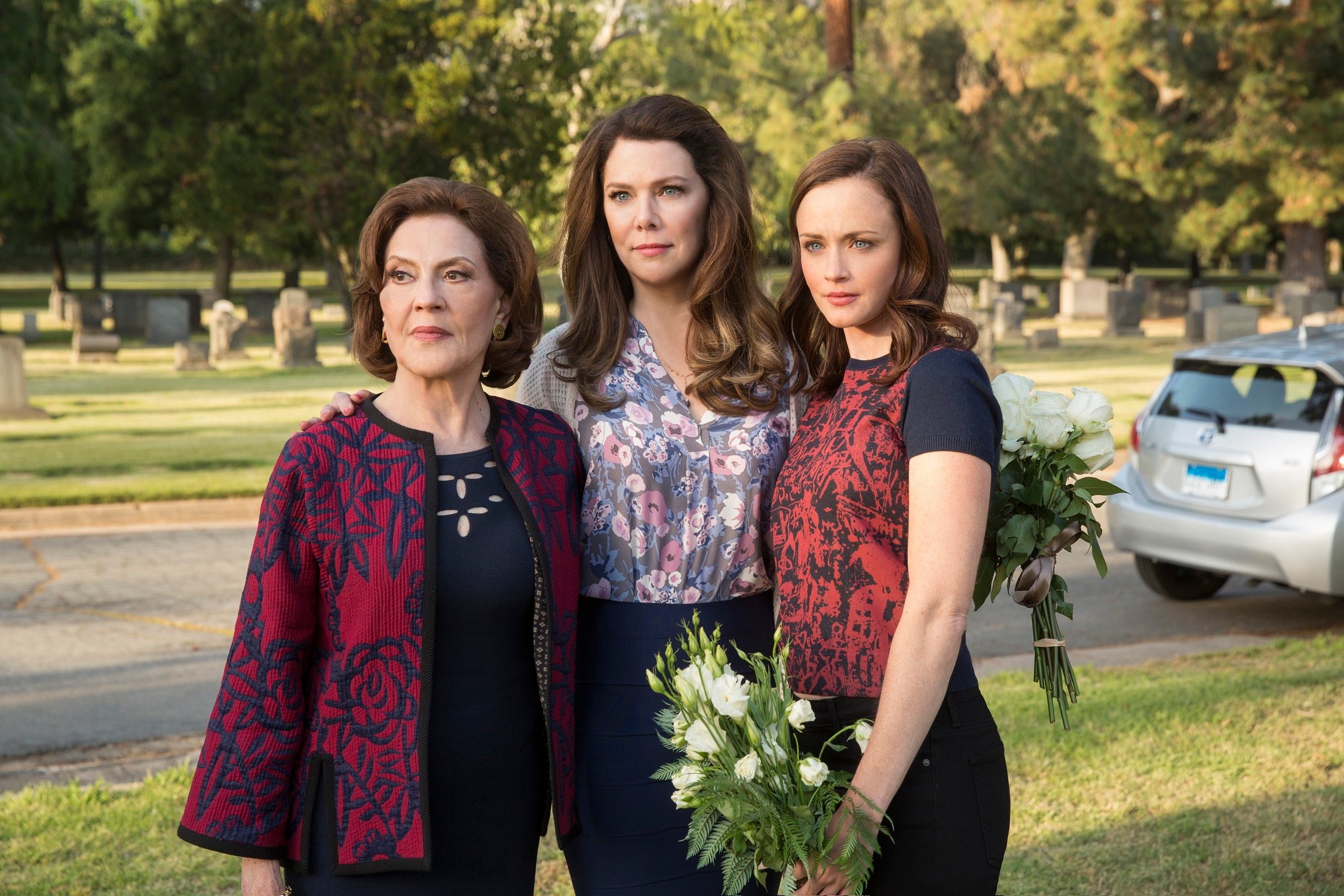 Kelly Bishop as Emily Gilmore, Lauren Graham as Lorelai Gilmore and Alexis Bledel as Rory Gilmore stand at Richard Gilmore's gravesite in 'Gilmore Girls: A Year in the Life'