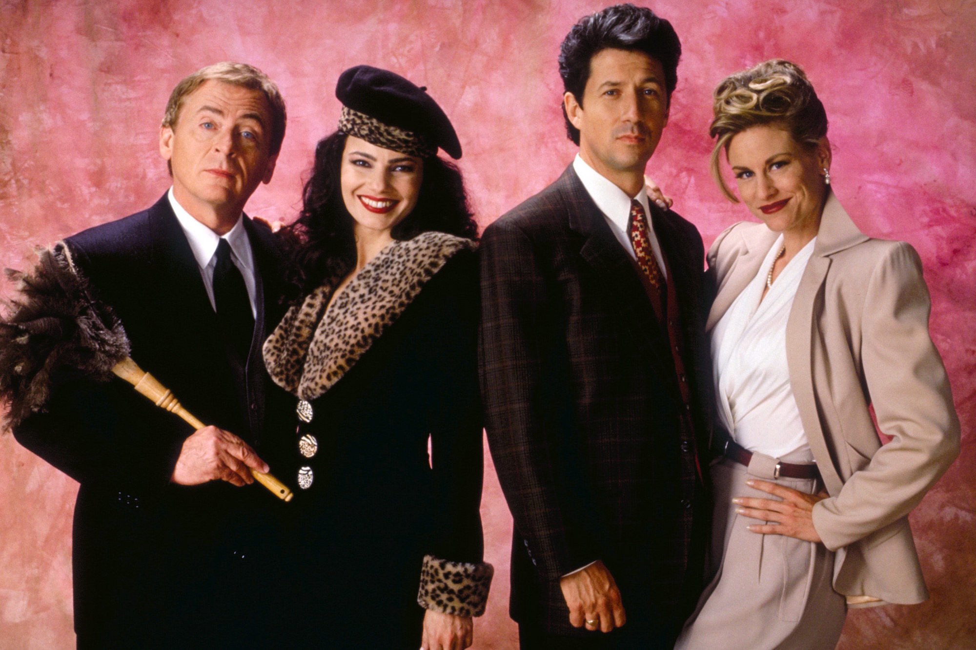 (L-R) Daniel Davis, Fran Drescher, Charles Shaugnessy, and Lauren Lane smiling in front of a pink background