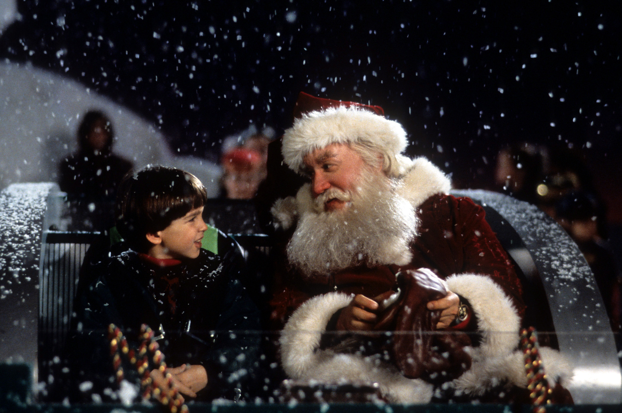 (L-R) Eric Lloyd as Charlie Calvin and Tim Allen as Scott Calvin/Santa Clause talking in a sleigh under snow