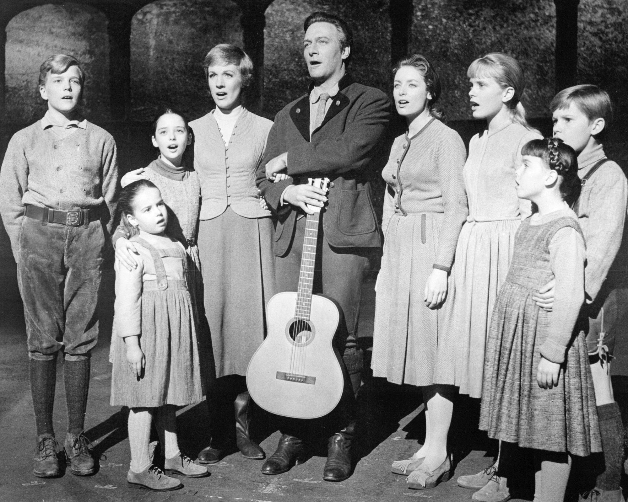 (L-R) Nicholas Hammond as Friedrich, Kym Karath as Gretl, Angela Cartwright as Brigitta, Julie Andrews as Maria, Christopher Plummer as Captain Von Trapp, Charmian Carr as Liesl, Heather Menzies as Louisa, Debbie Turner as Marta and Duane Chase as Kurt singing, in black and white