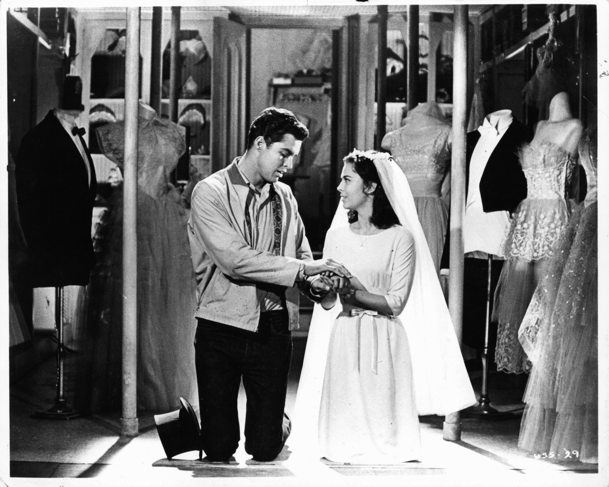 (L-R) Richard Beymer and Natalie Wood having romantic moment wardrobe shop in a scene from the film 'West Side Story',