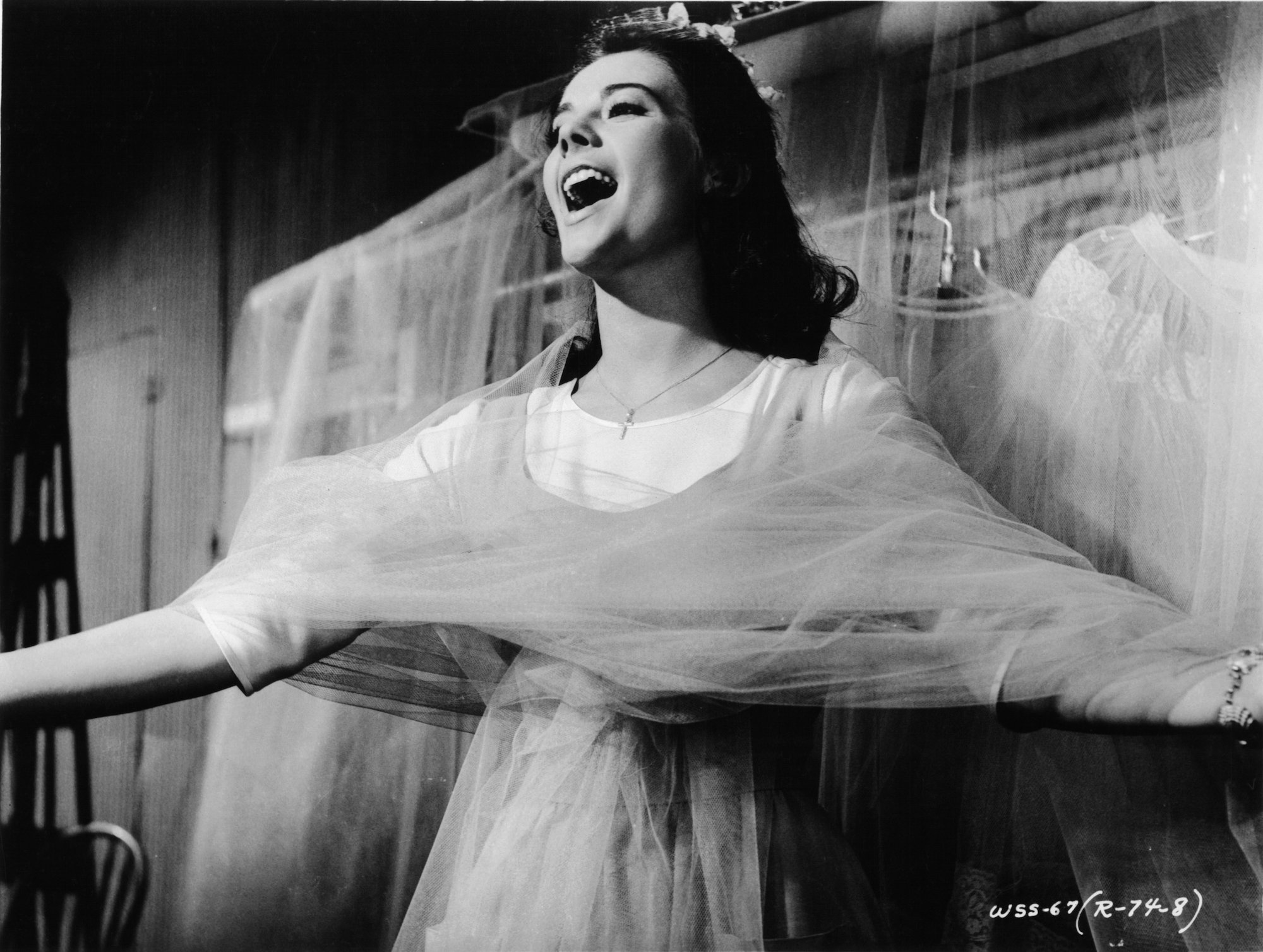 Natalie Wood wrapped in chiffon while singing in a scene from the film 'West Side Story'