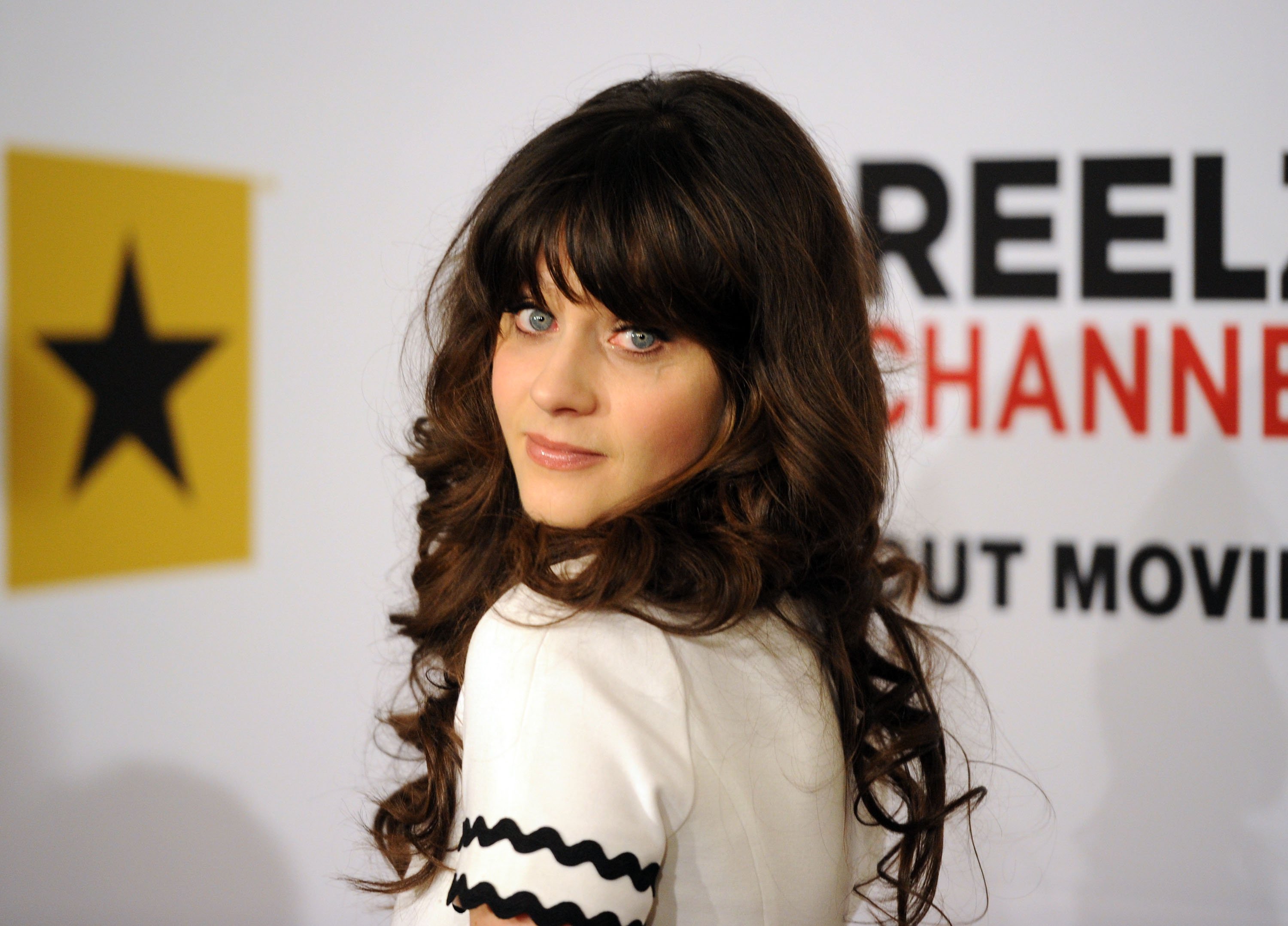 Zooey Deschanel poses for a photo on the red carpet
