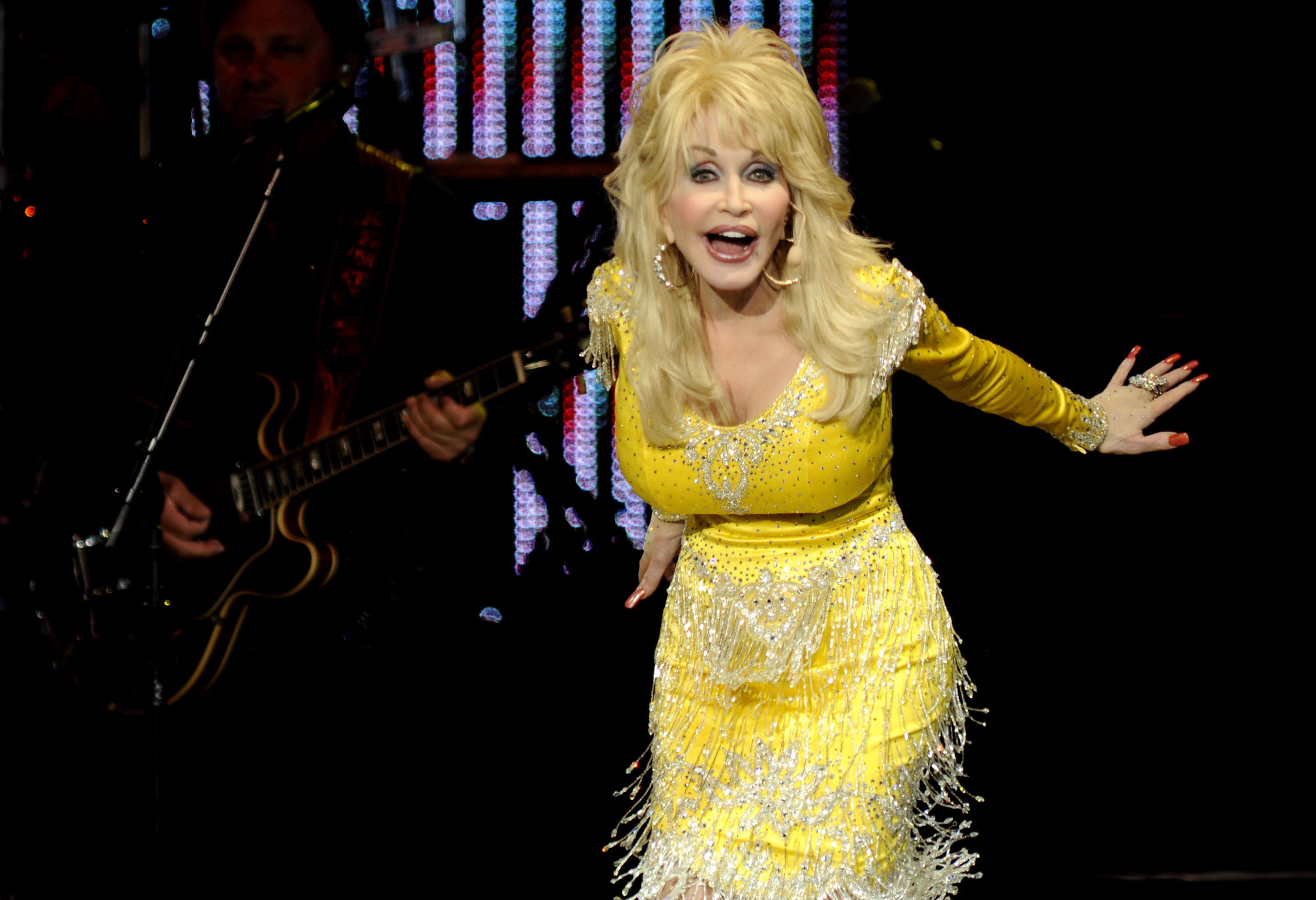 Dolly Parton in a yellow dress