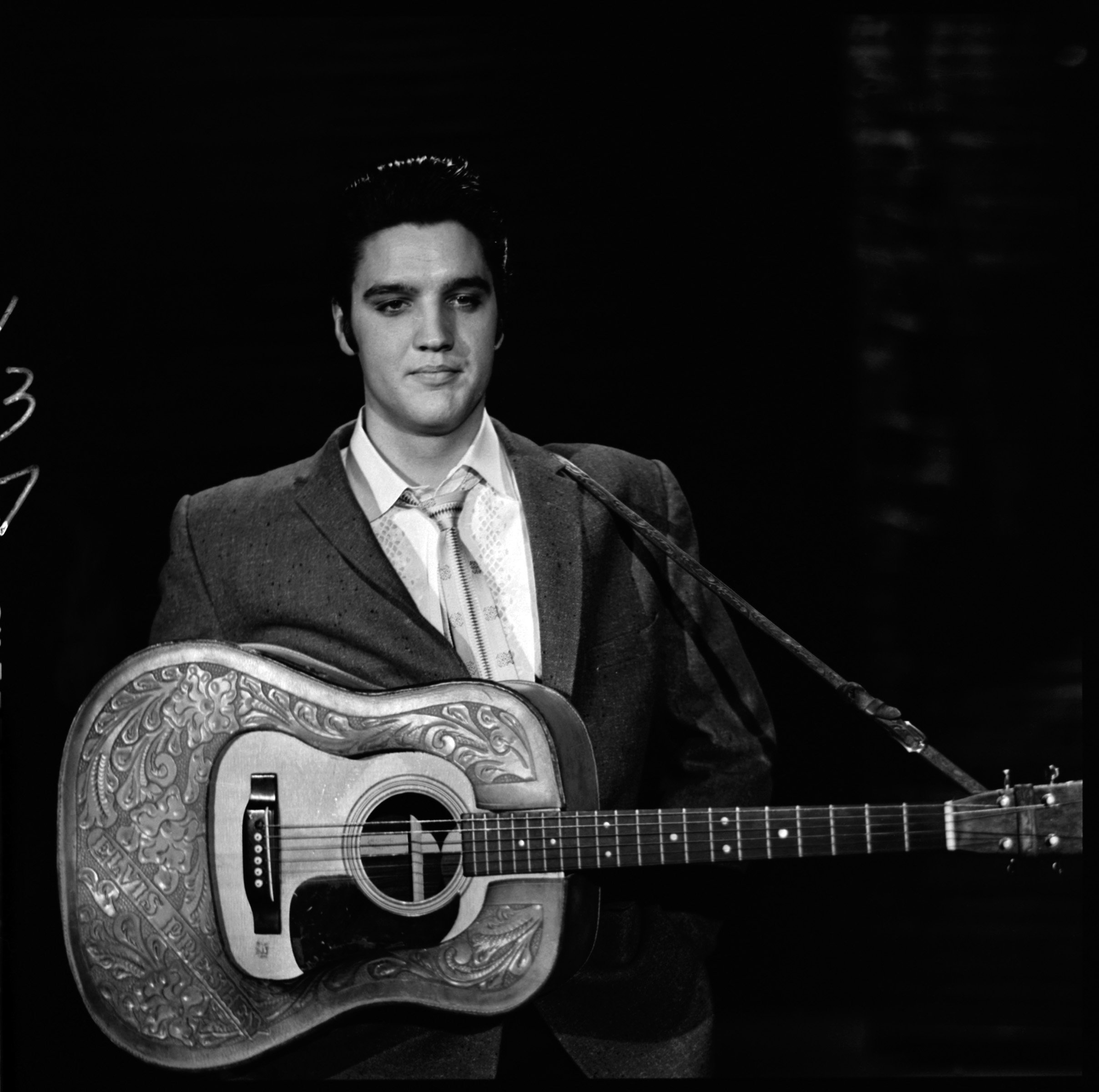 Elvis Presley holding a guitar
