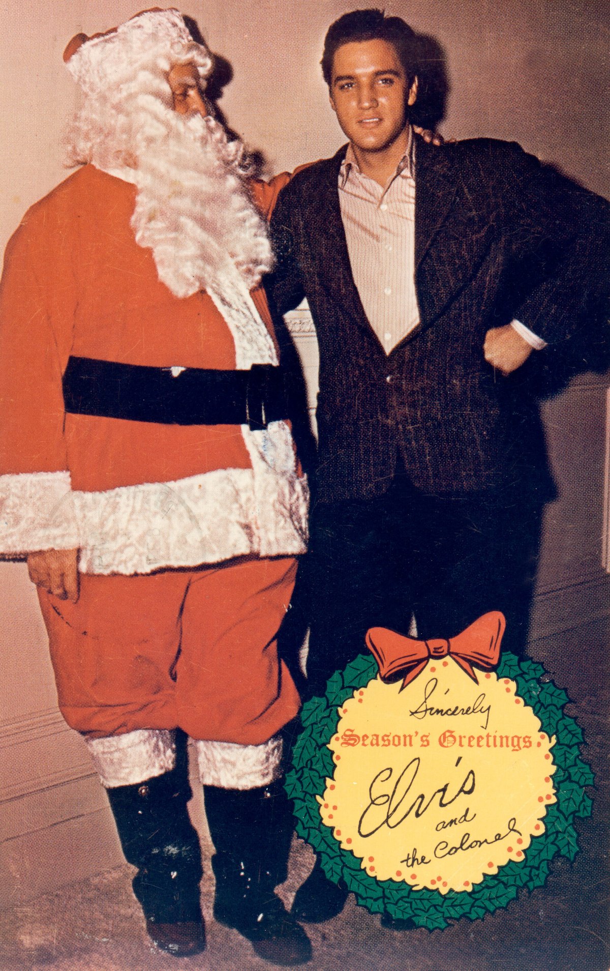 Elvis poses with Colonel Tom Parker as Santa