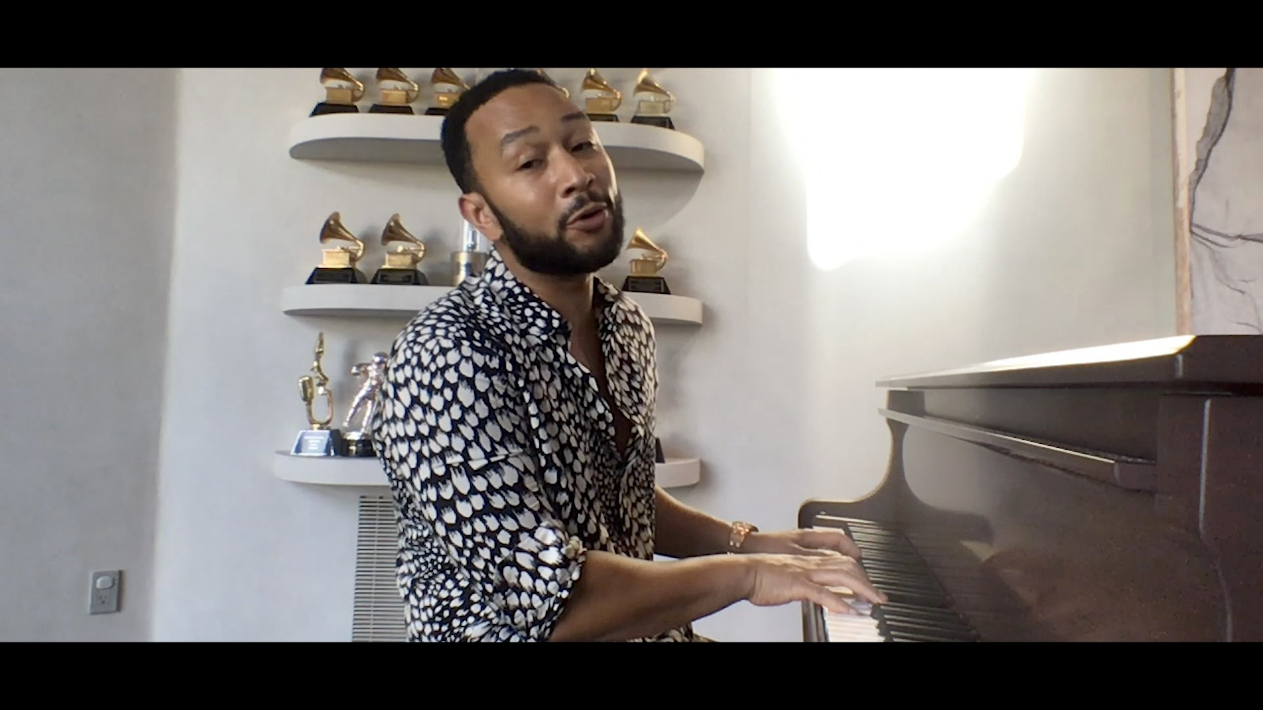 John Legend at a piano