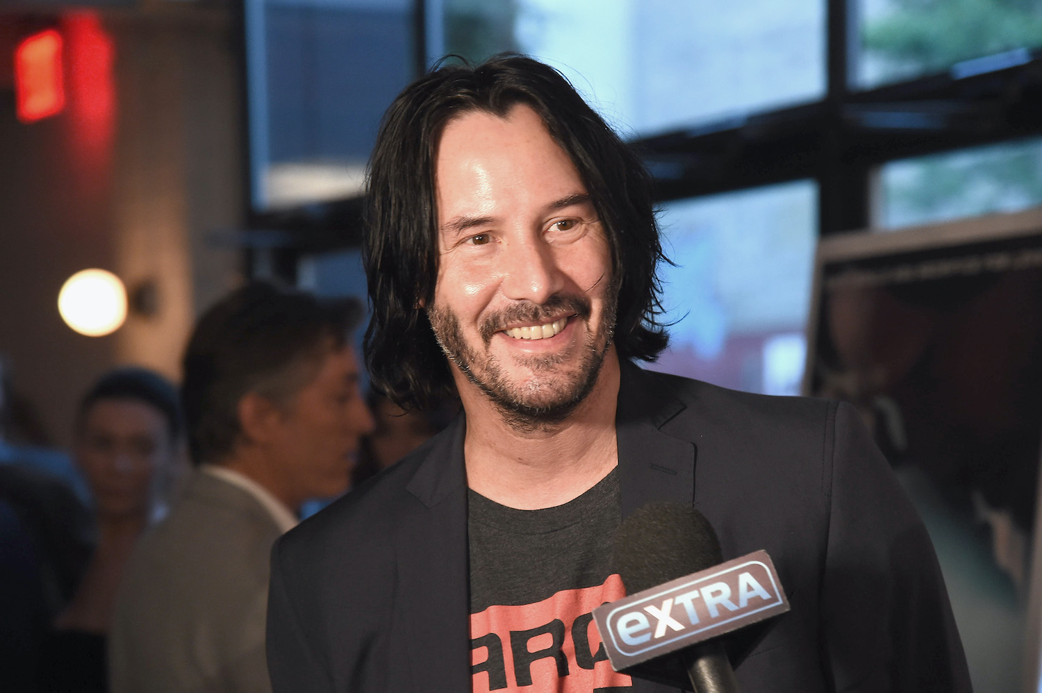 Keanu Reeves smiles while he attends the 'Siberia' New York premiere in 2018