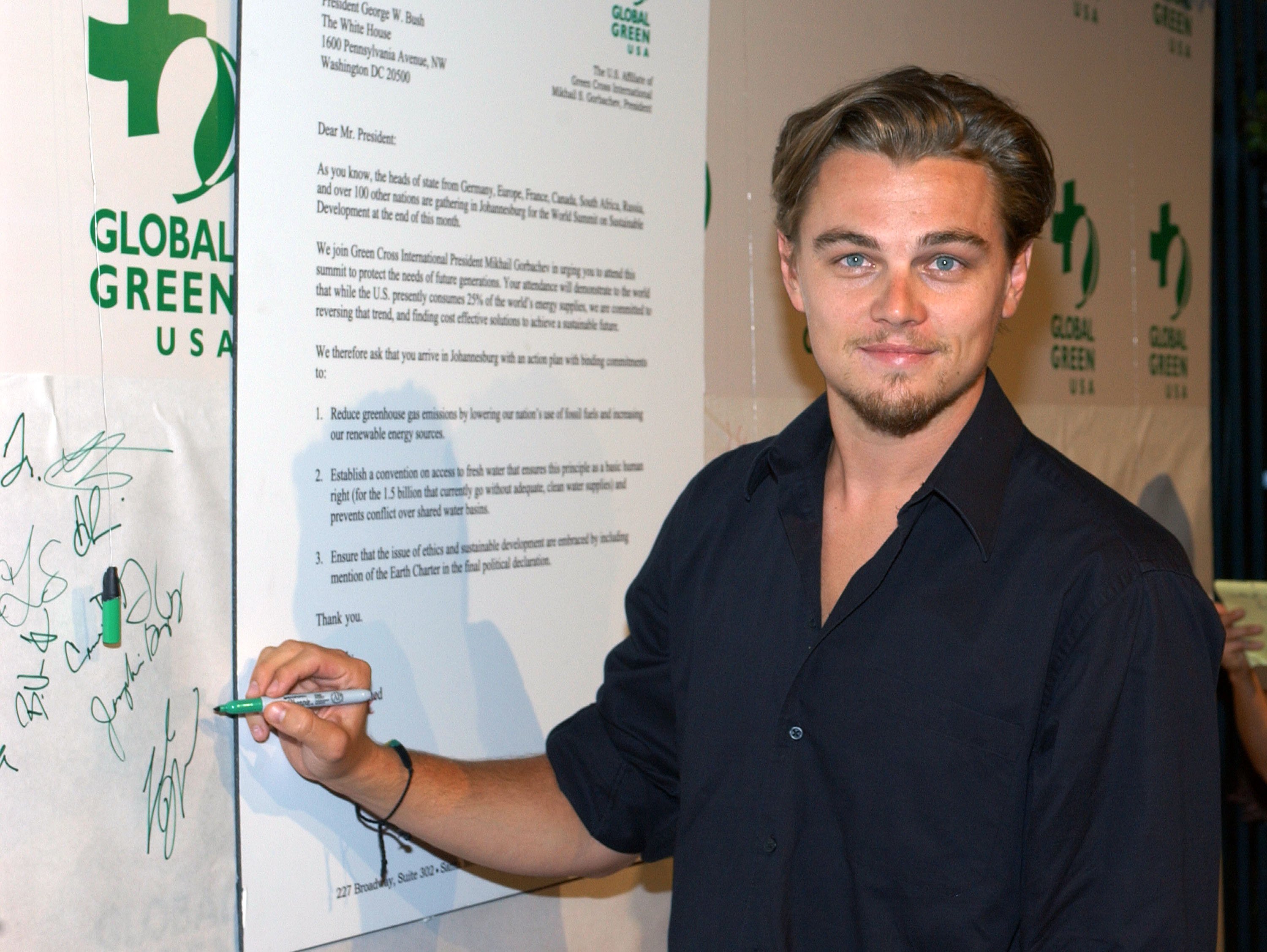 Titanic star Leonardo DiCaprio near a poster