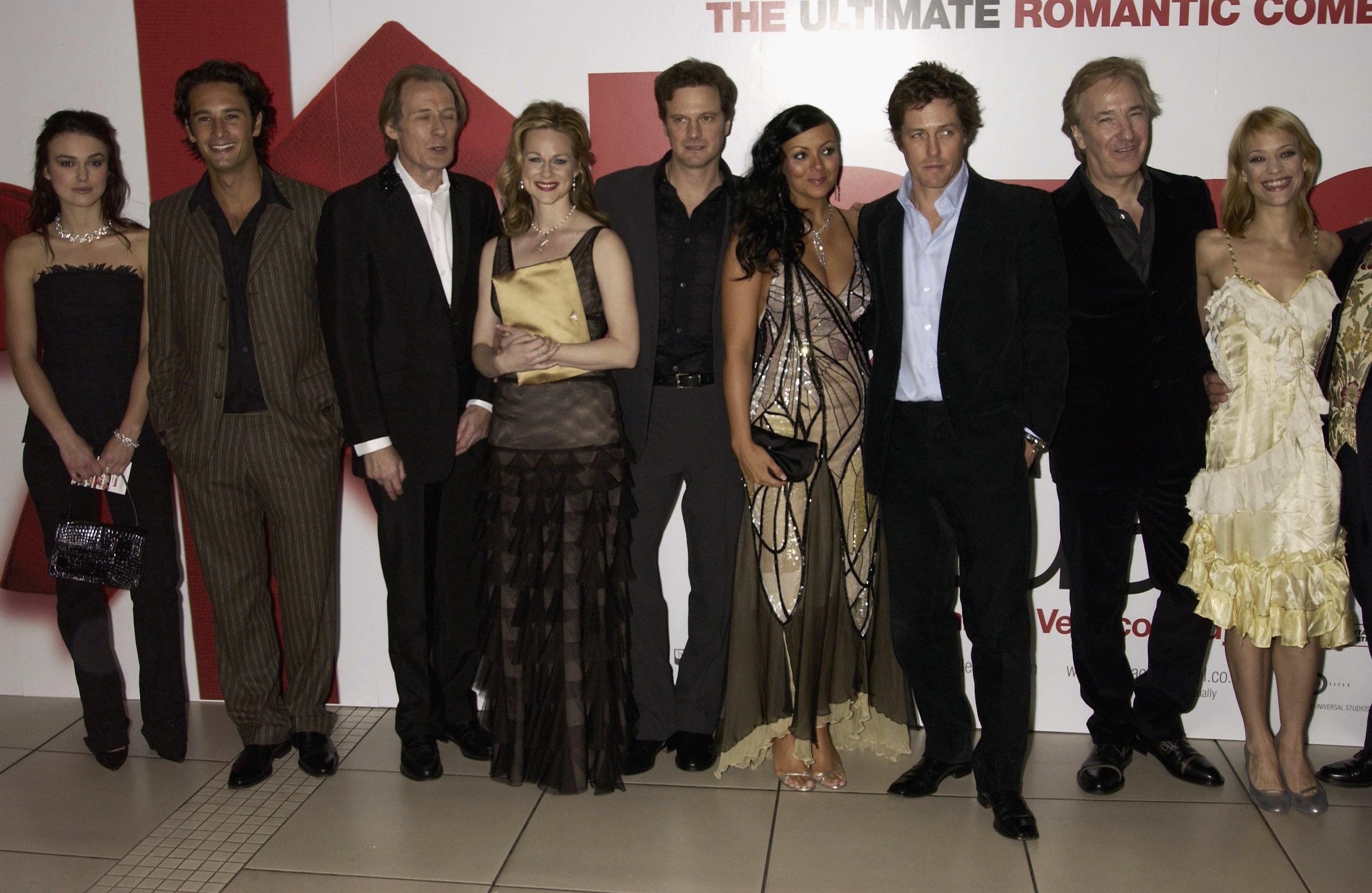 (L-R): Keira Knightley, Laura Linney, Colin Firth, Martine McCutcheon, Hugh Grant, and Alan Rickman attend the UK Premiere of 'Love Actually' on November 17, 2003 in London. 
