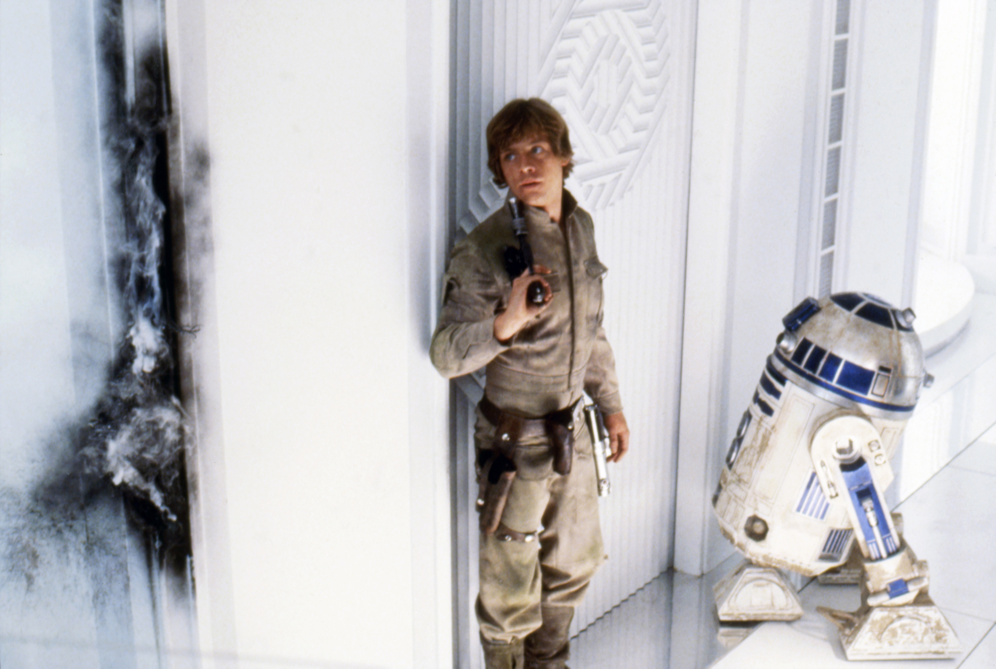 Mark Hamill (Luke Skywalker) and Kenny Baker (R2-D2) on the set of 'Star Wars: Episode V - The Empire Strikes Back' directed by Irvin Kershner
