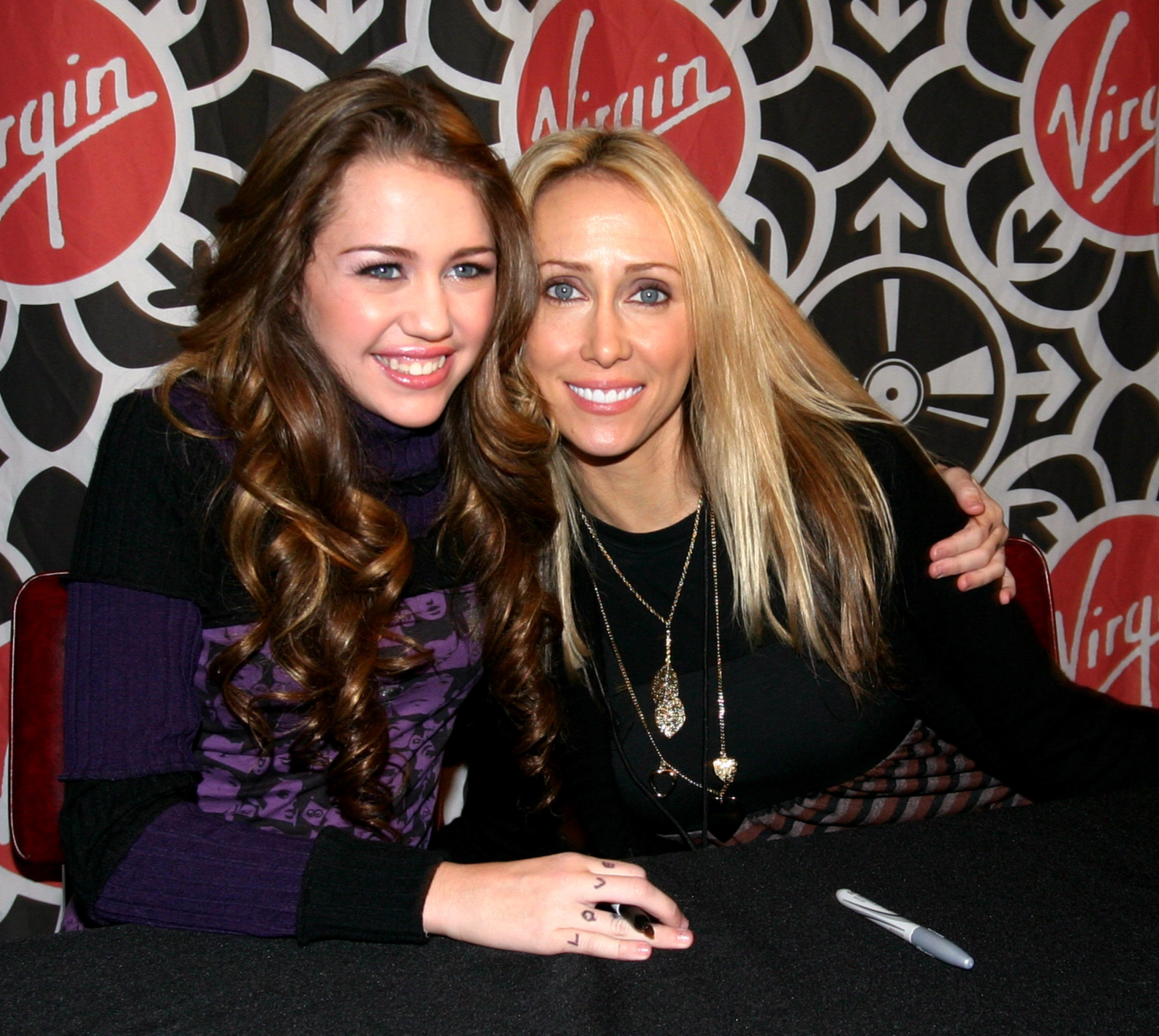 Miley and Tish Cyrus at a table