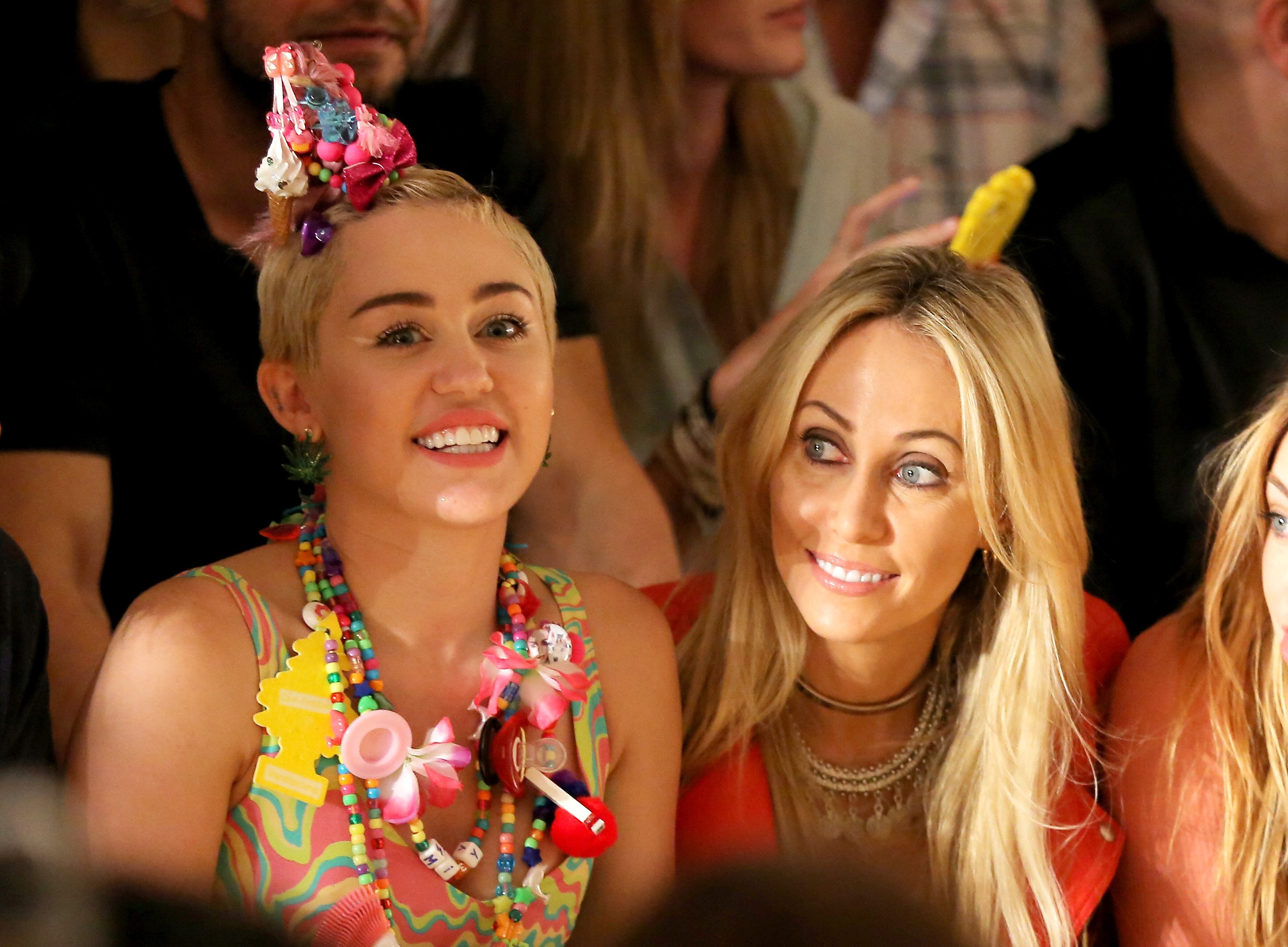 Miley and Tish Cyrus in front of people